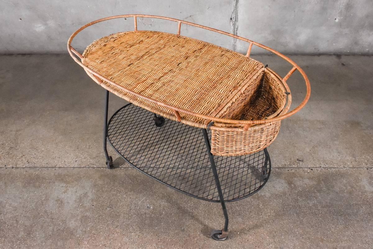 An uncommon serving cart designed by Maurizio Tempestini for Salterini with a rattan top and expanded metal base. This piece is in nice original condition, there is some minor loss of the rattan as pictured.

Measures: 42