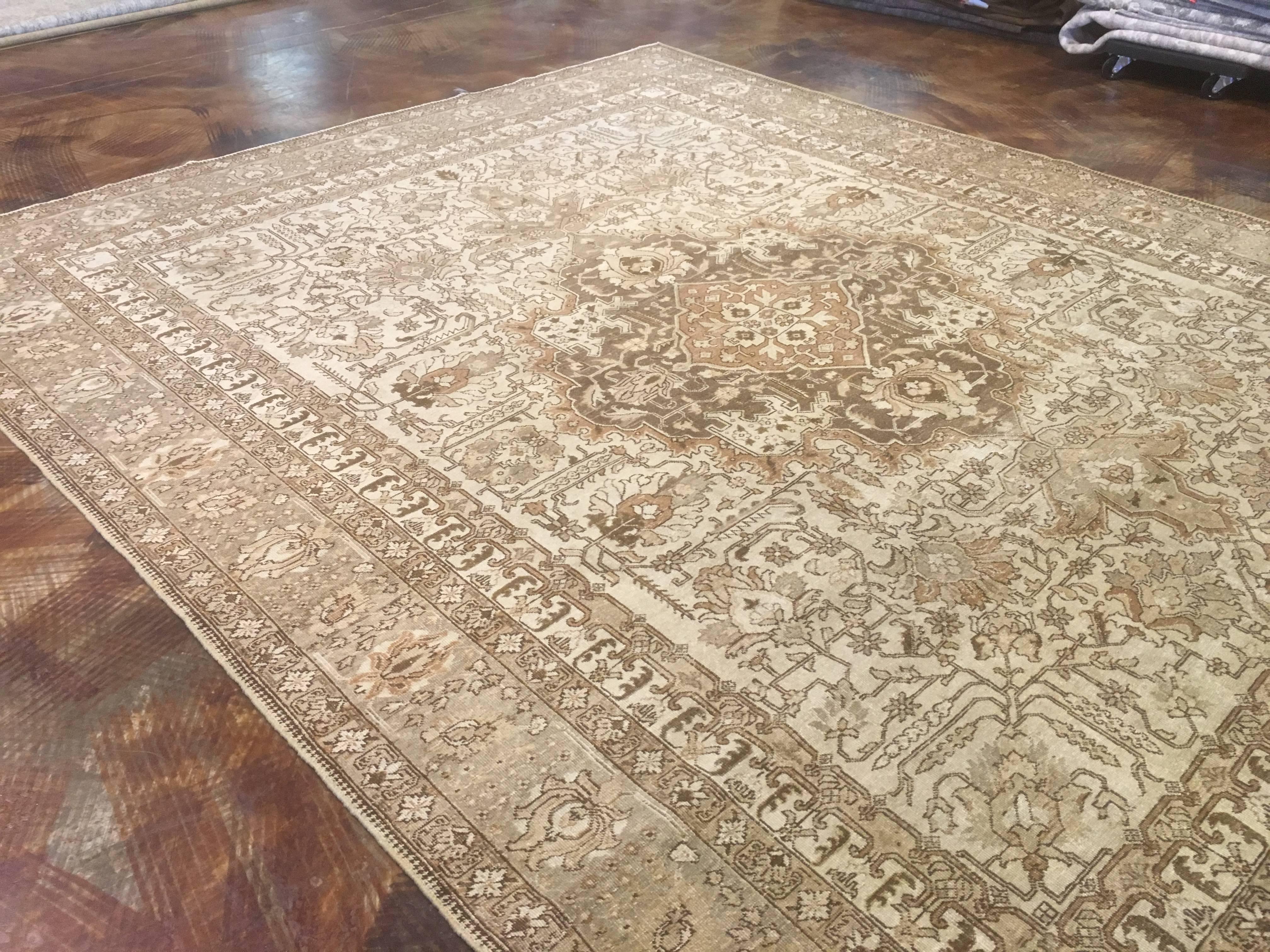 Persian Tabriz woven around the early 1900s 8.10 x 11 ft. it is in excellent low pile condition. 
Very soft earth-tone colors have been achieved in a sun-wash process. This process is a very slow and safe way to bring down the strong tones to