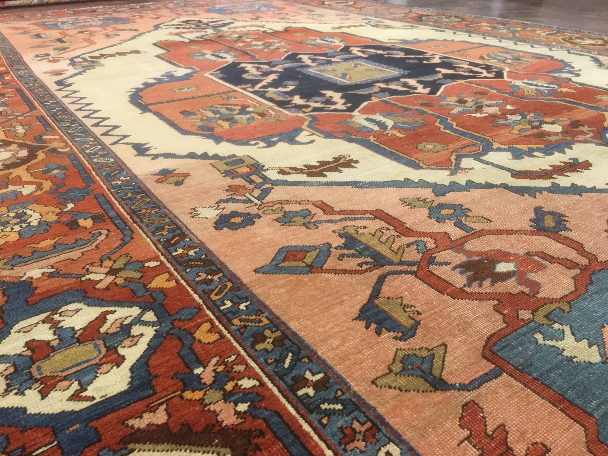 Great Persian Serapi rug woven in the late 1800s by weavers in Persia. This is a piece that show it originality and symmetry. There are no duplicate flowers or even a balanced medallion. All of the traits that we love about a nomadic Serapi rug of