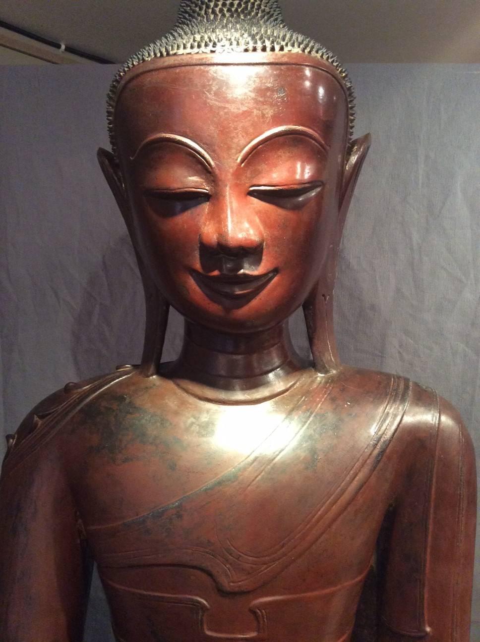 Huge Buddha statue in lacquer, in the mudra of the bhūmisparśa, formerly gilt, later Shan state period (1885-1948), from the region of Shan, Burma, Myanmar. 
The bhūmisparśa 