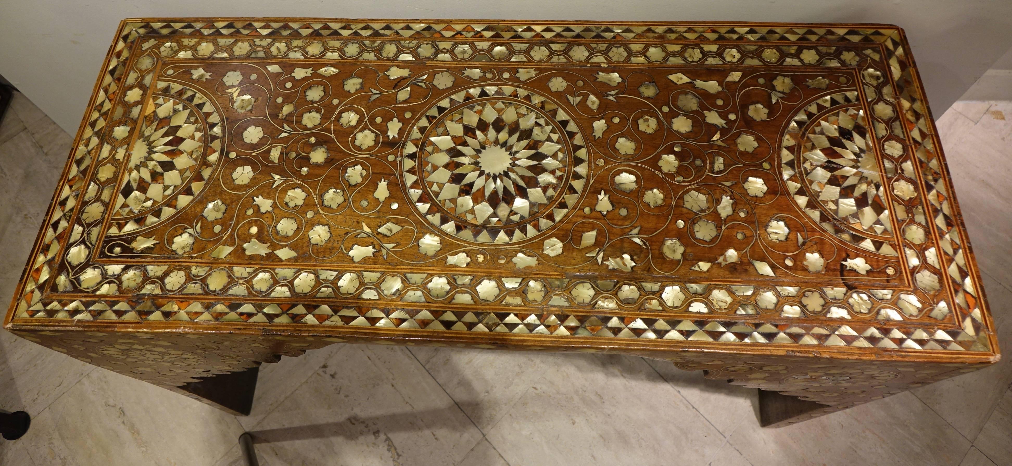 Rare writing table that can serve also as a wooden console, inlay with mother-of-pearl and shell.
Beautiful decor on four sides made of geometric compositions and trees of life.
Syria, Ottoman Empire, 19th century.