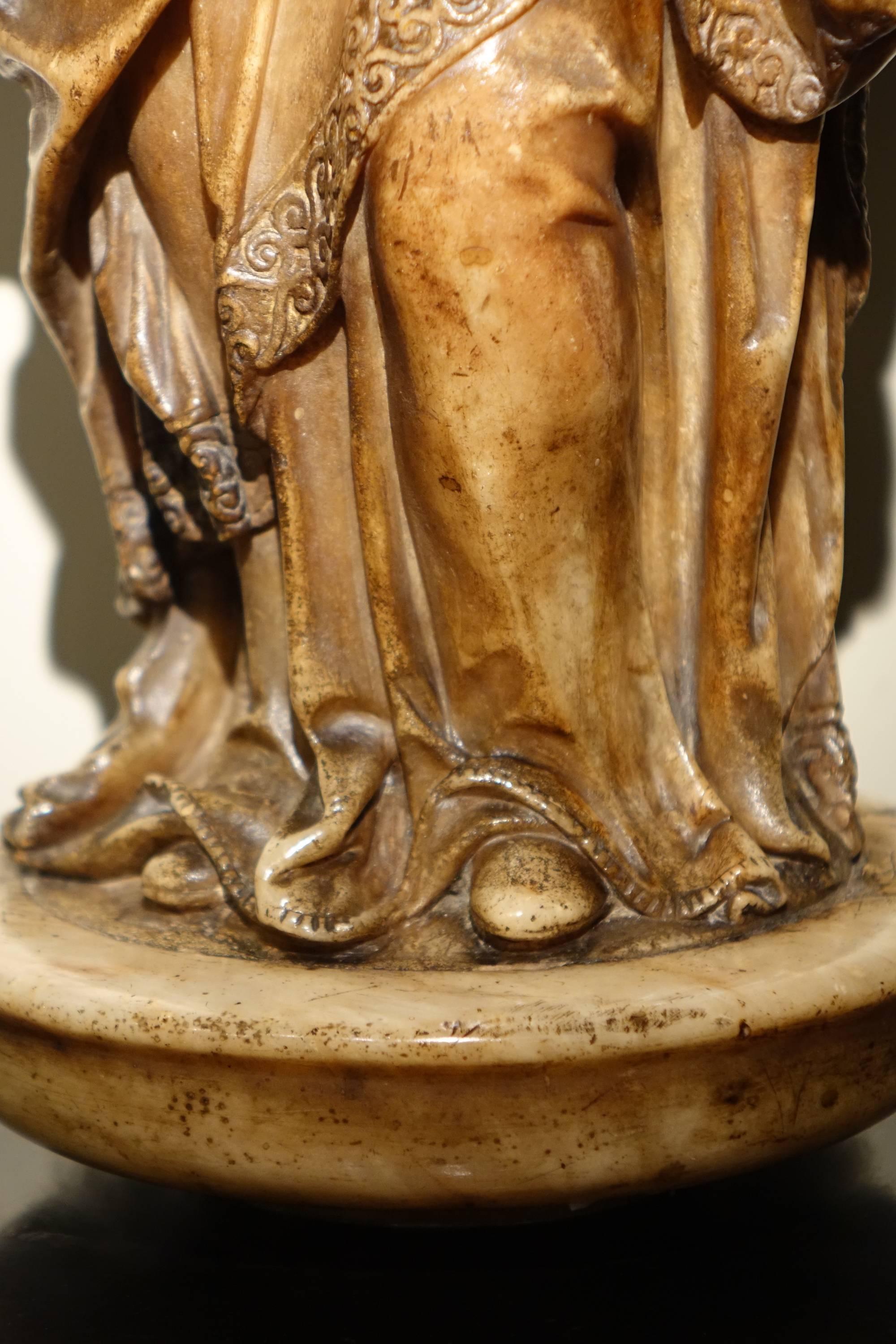 Virgin and child, freestanding, sculpture in the round, alabaster.   16th century 
The Virgin, richly dressed, is looking over the child who is slightly detached from her. The arms of the child - which are missing- must have carried the globe or