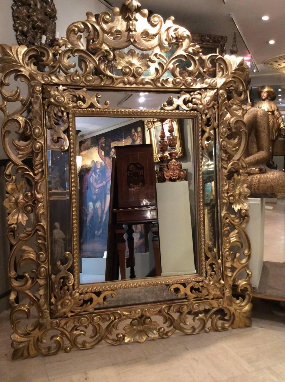 19th century sculpted giltwood mirror with partitions. Beveled mercury mirrors. Central mirror was changed as too damaged.
Italian workshop, second half of the 19th century, probably Rome, Italy.

