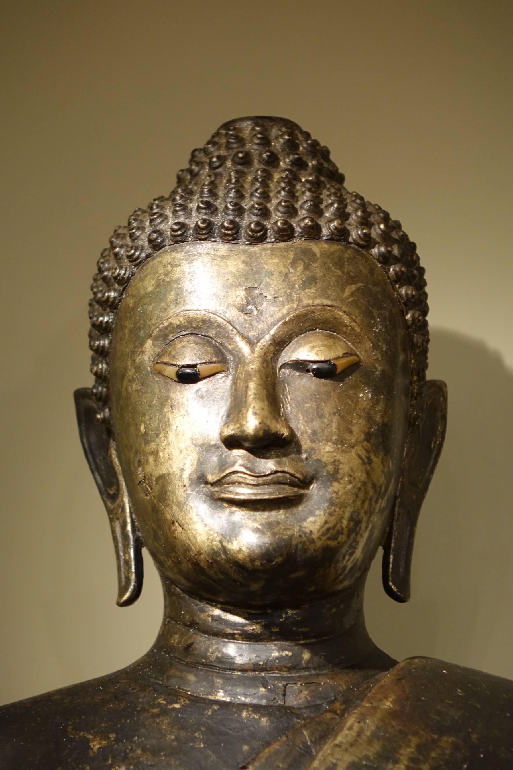Buddha standing in Abhaya Mudra Gesture, lacquered bronze, Thailand, circa 1860
The Abhaya Mudra (Mudra of no-fear) represents protection, peace, benevolence and dispelling of fear.
Thailand, 19th century.
 