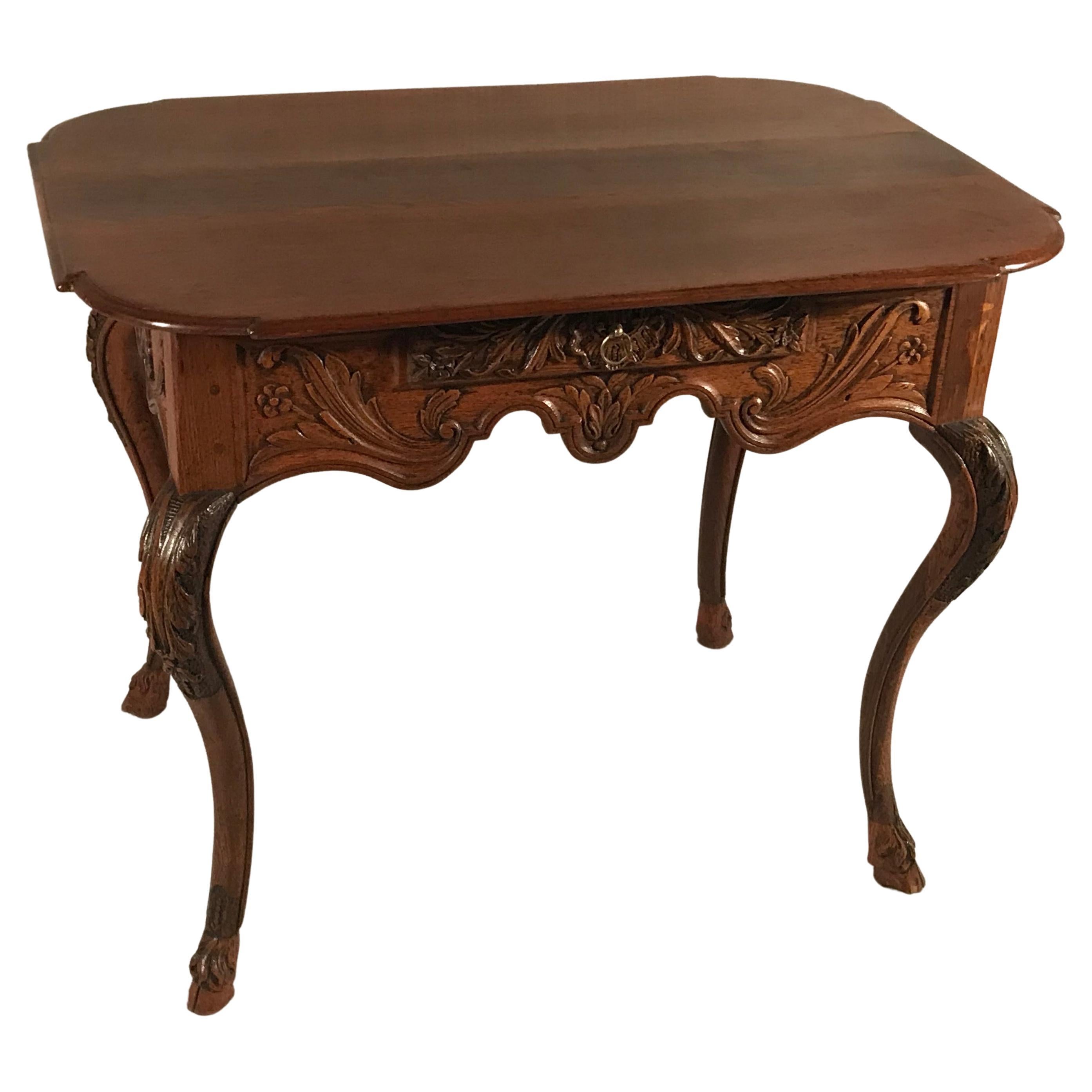 This stunning 18th-century Baroque table, crafted in Flanders around 1750, is a true masterpiece of antique furniture. Made from solid oak, it features exceptional hand-carved details, including rocaille, floral, and leaf motifs, all characteristic