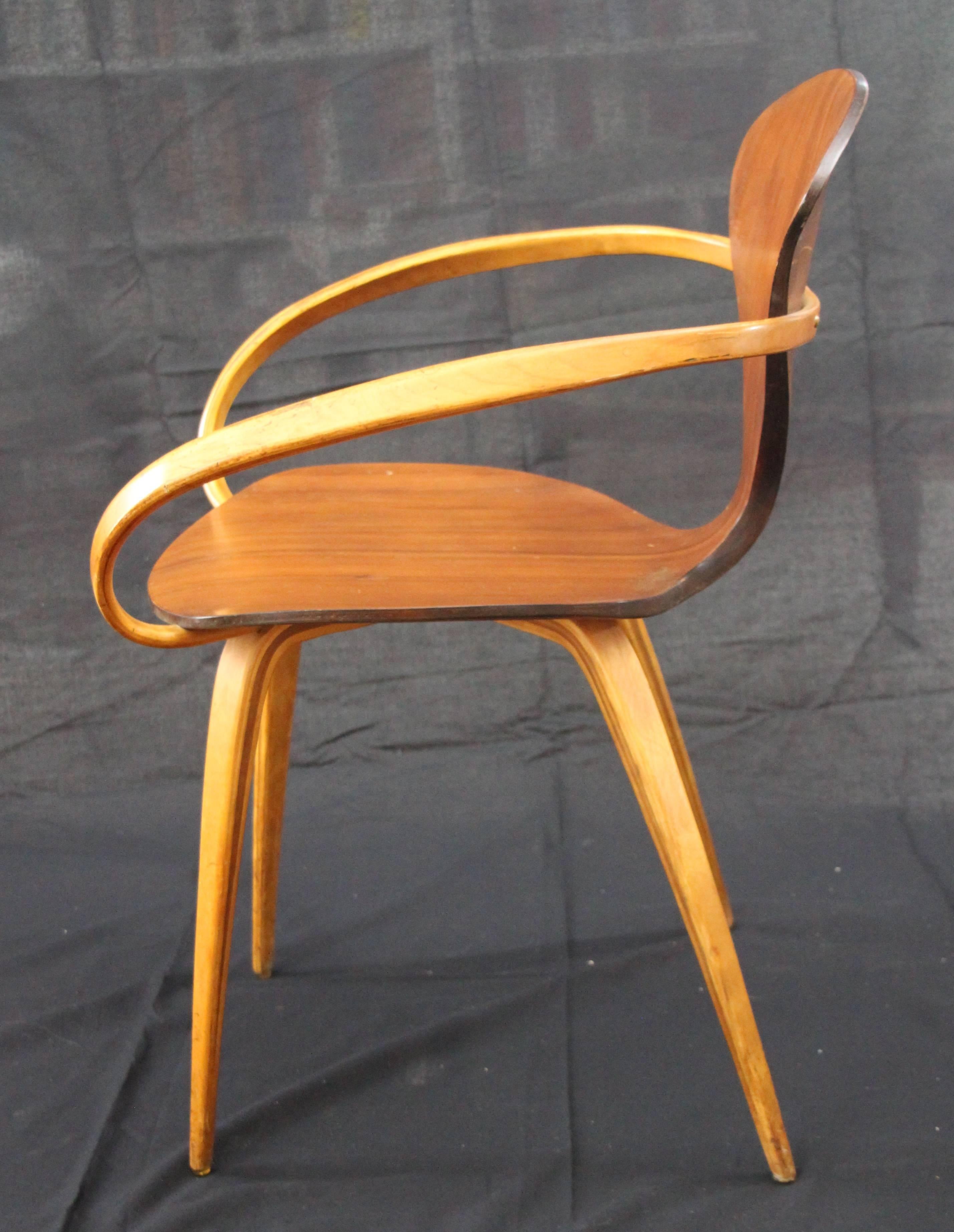Midcentury armchair in walnut and beech. The chair was designed in the late 1950s by Norman Cherner (1920-1987) for Plycraft. Even though Plycraft told Cherner that the design would not be produced, the company started the production as its own