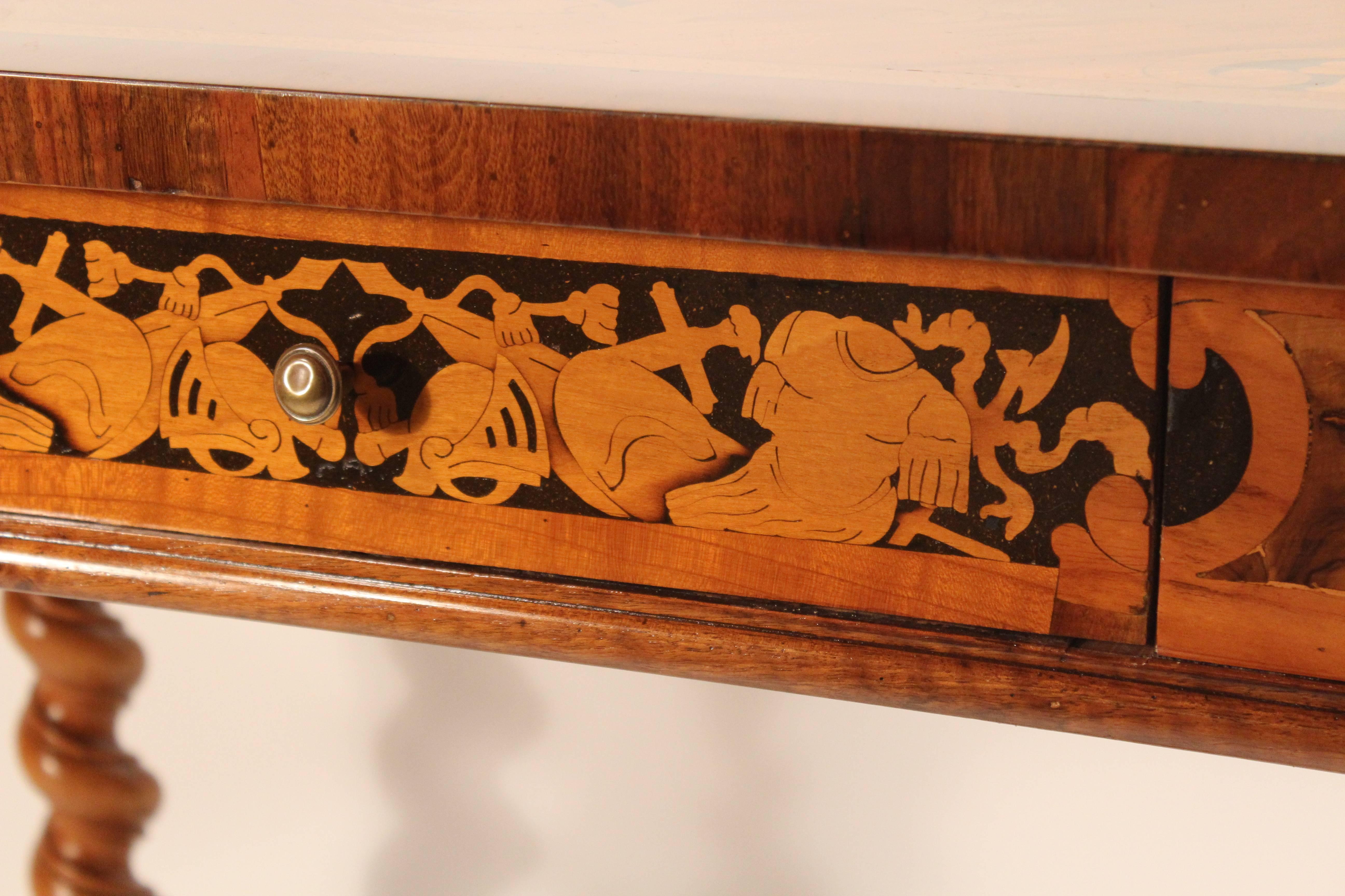 Unique baroque table made around 1750 in South Germany. 
Exquisite marquetry in cherrywood, kingwood, walnut and elm. The marquetry depicts presentations of roman weapons and armor on apron and top. The central medallion on the top shows a