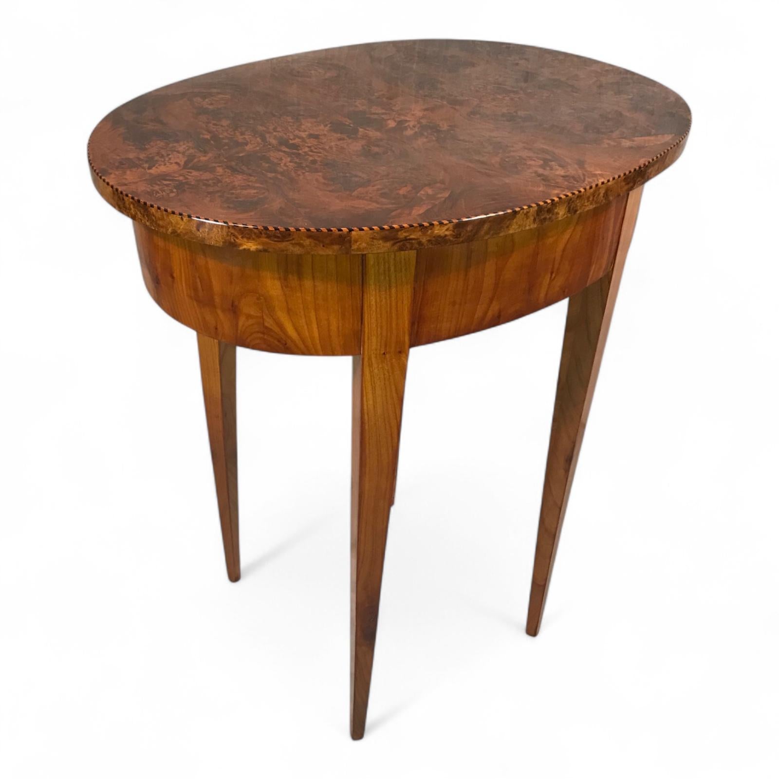 Oval Biedermeier Side Table in Cherry with Maple Root Veneer, Germany circa 1820
This elegant oval Biedermeier side table from Germany, dating to around 1820, is a superb example of the refined craftsmanship and restrained beauty typical of the