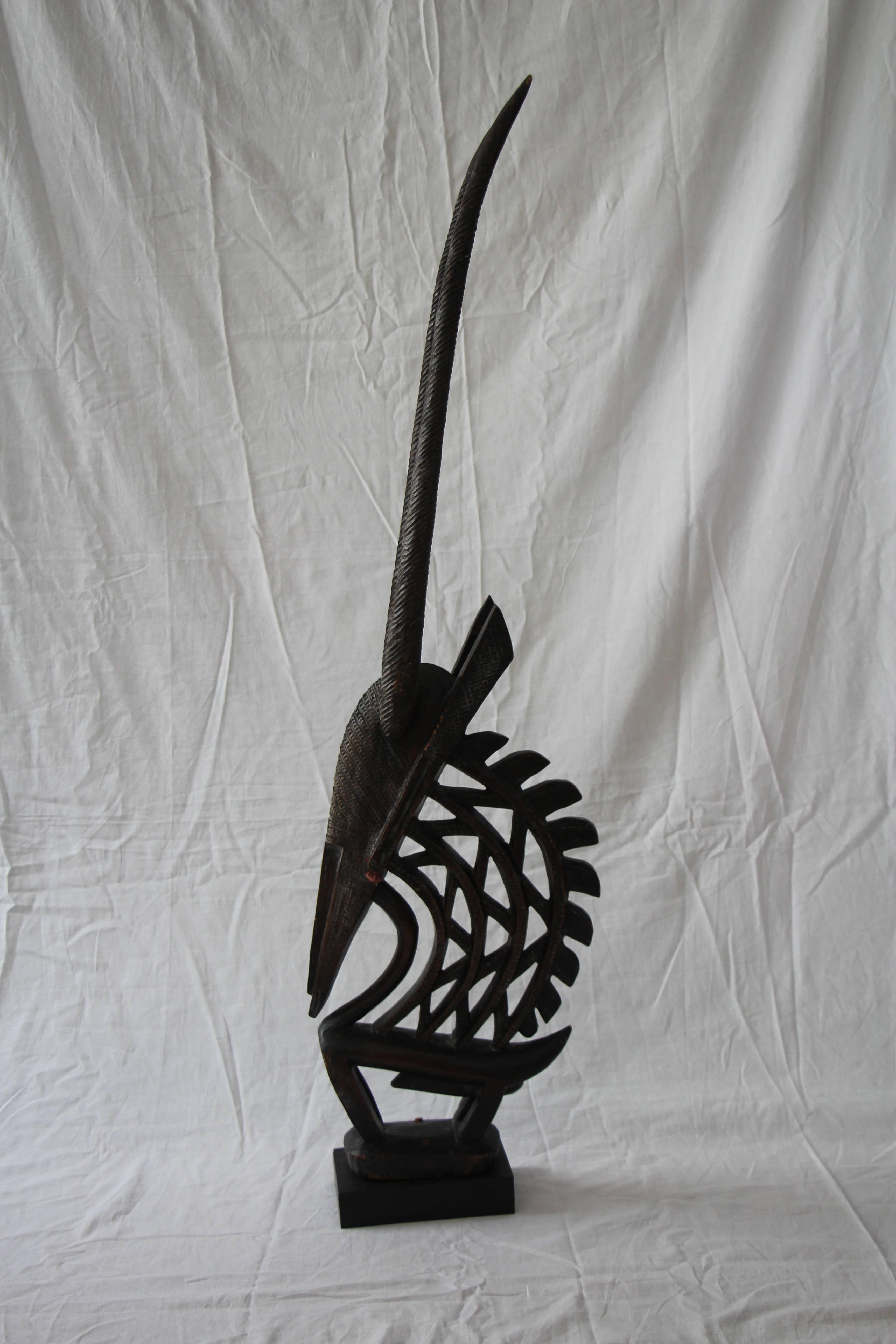 Segou Mali antelope headdress mask-Chi Wara- northern region style with the hand-carved unique wood articulated triangular body motif. With red thread ear embellishments. A wonderful aged patina and appearance due to age and use. This type of