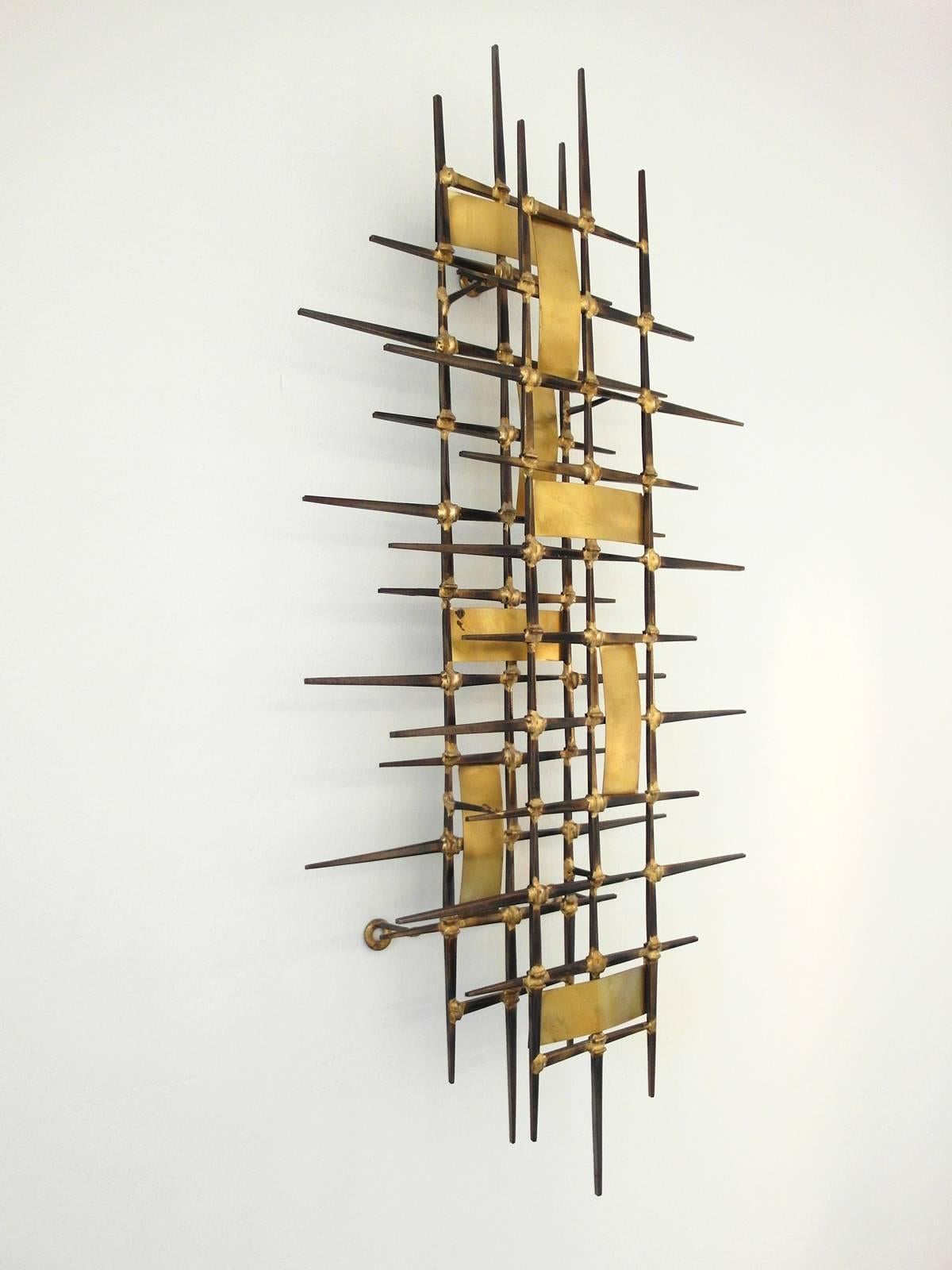 Beautiful nail wall sculpture attributed to Ron Schmidt (unsigned.)
A Mid-Century Brutalist nail art sculpture with gold brazed patinated nails and shiny brass panels. 
This sculpture can be arranged vertically or horizontally. Very good condition