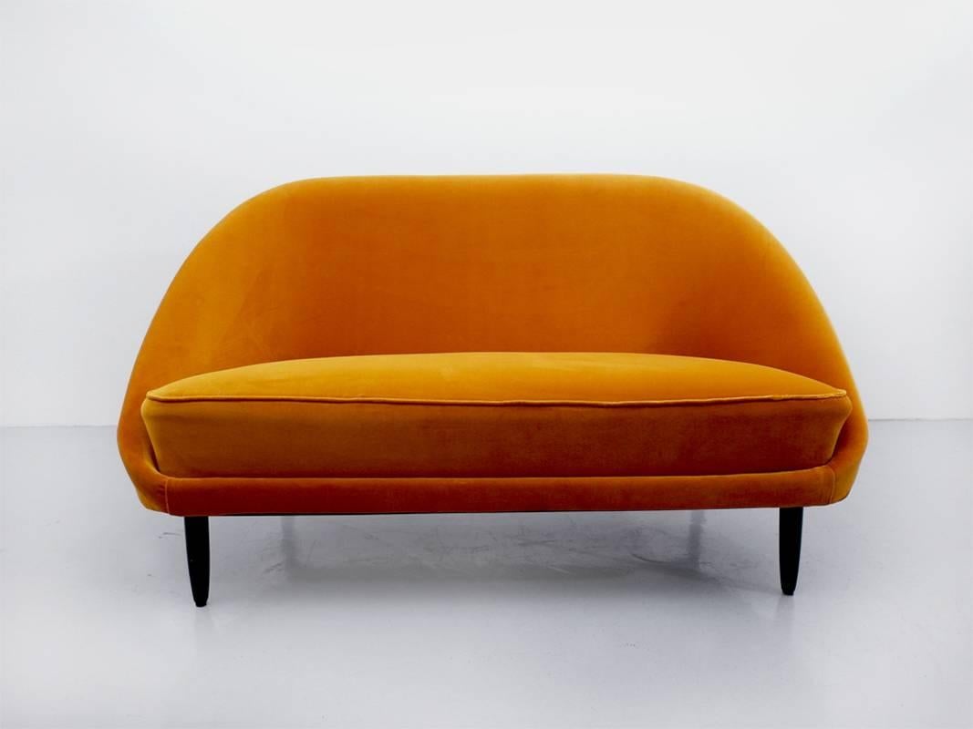 Rare two-seat sofa designed by Theo Ruth for Artifort, The Netherlands 1959. This two-seat sofa is a design classic from the 1950s.The black stained beech wooden frames feature an elegant integrated back rest which contrasts beautifully with velvet.