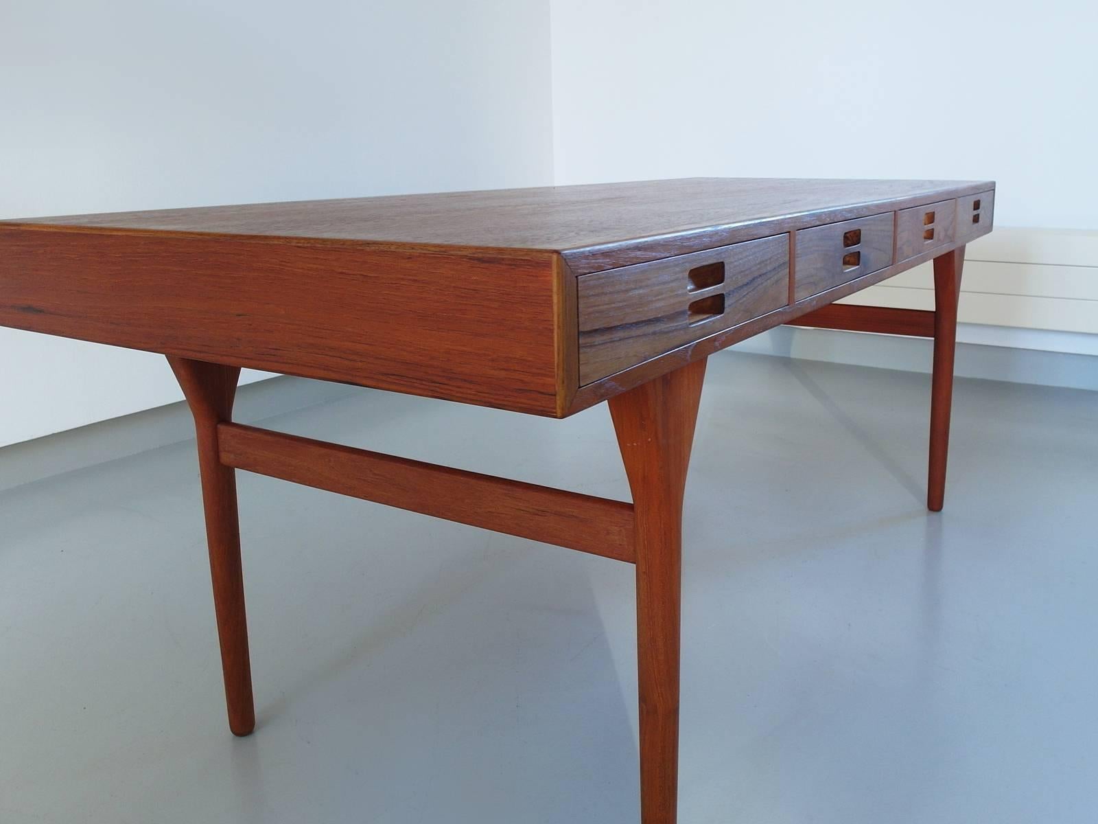 Beautiful freestanding writing desk designed by Nanna Ditzel for Søren Willadsen, Denmark, 1958. Perhaps the most beautiful Mid-Century desk ever designed. 
This exclusive teak desk is in pristine, fully restored condition and has a refined wood