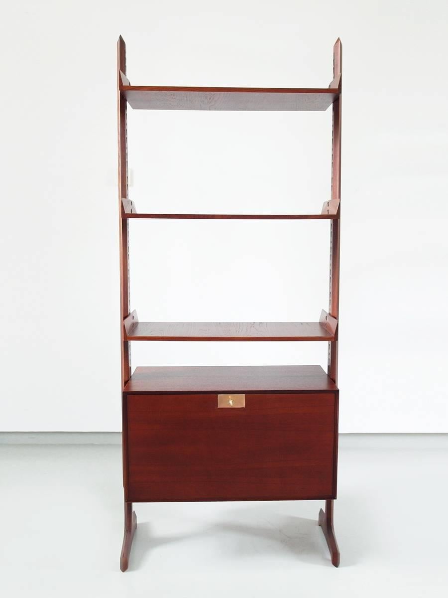 Free standing wall unit designed by Vittorio Dassi, Italy 1960. This elegant mahogany wall unit has adjustable open shelves over an interchangeable case element with folding door which could also be used as a small desk. The case is beautifully