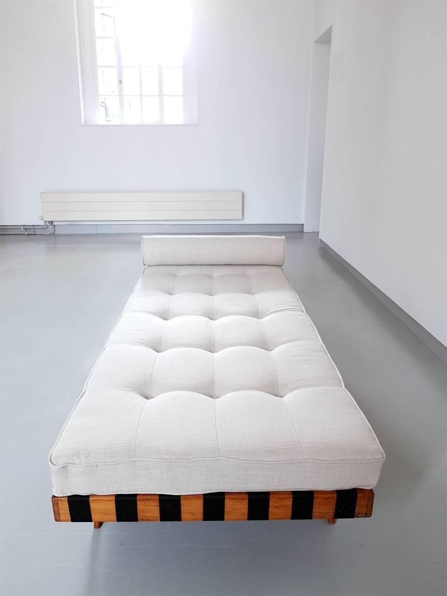 Scandinavian Minimalist birch wooden daybed in the style of Jens Risom and Klaus Grabe. This beautiful and sleek daybed features black webbing which creates a great graphic patterned outline of the bed. The daybed has recently been upholstered with