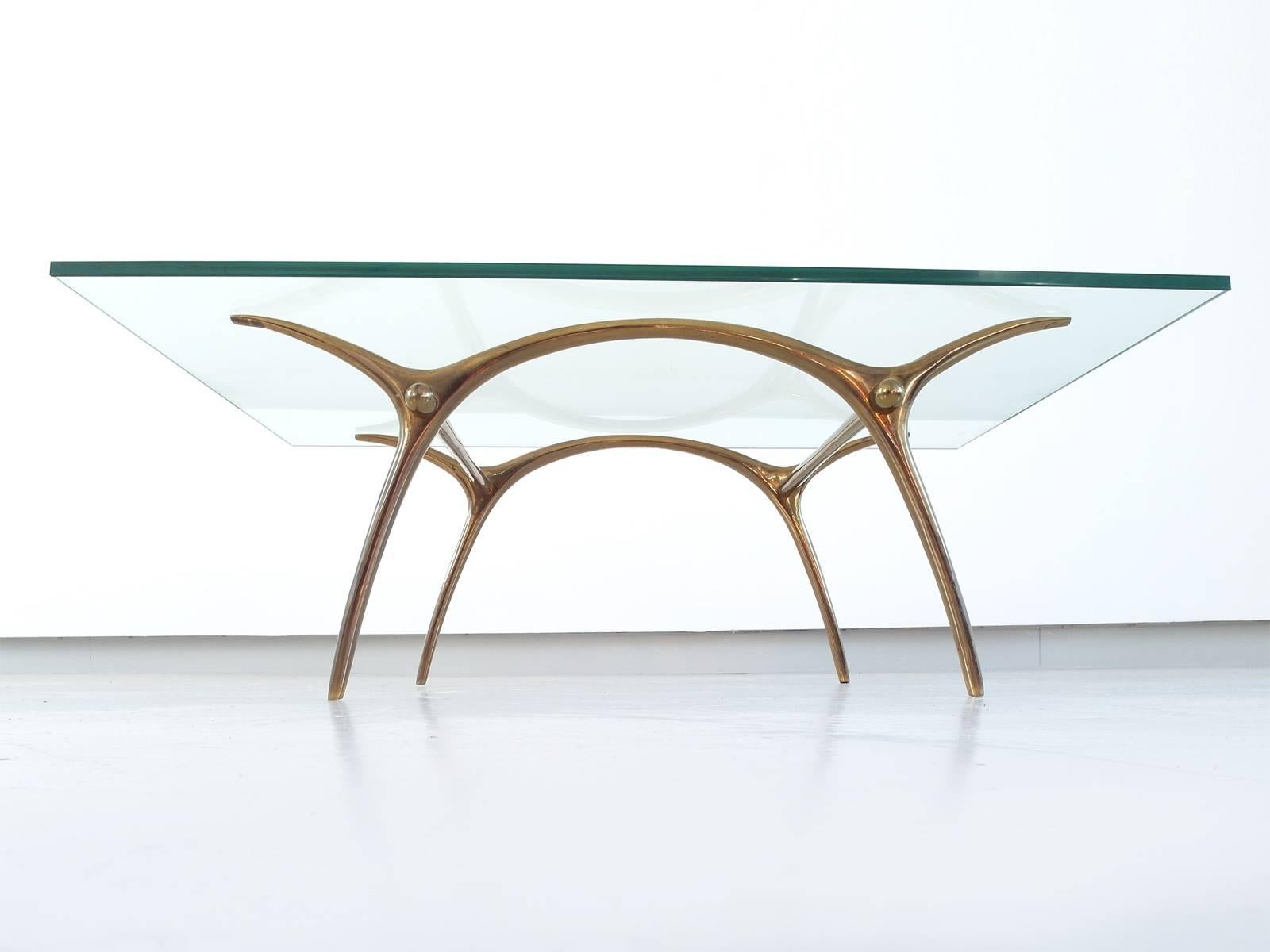 A bronze and glass coffee table designed by Kouloufi for Ets Vanderborght Frères SA, Brussels 1958. Vanderborght Frères was a Brussels-based interior company, similar to Maison Janssen or Maison Baguès. This high quality rectangular coffee table