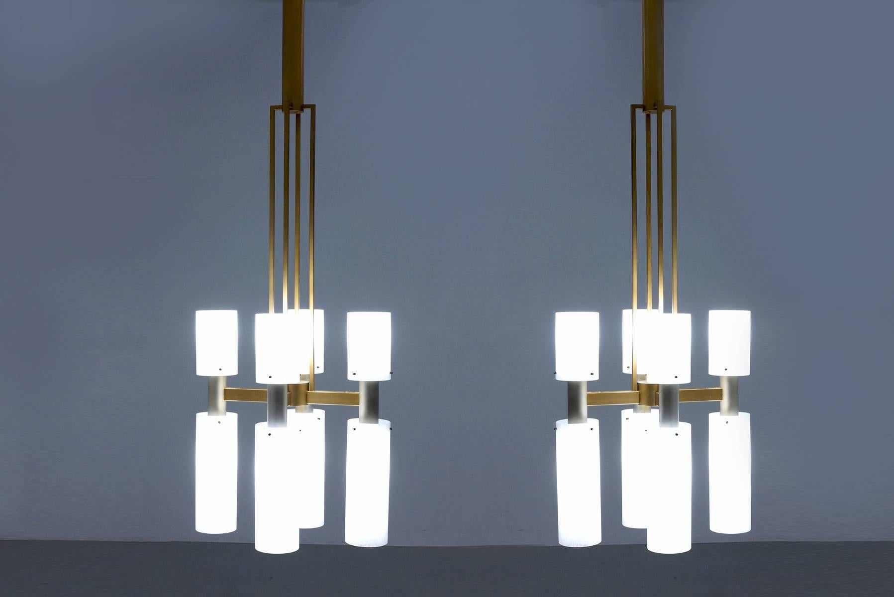 Monumental pair of early Mid-Century Modern chandeliers executed in glass and bi-colored bronzed metal. These high quality chandeliers were custom-made in the Netherlands, circa 1948-1950 and feature a total height of 64.56 in. / 164 cm. The design