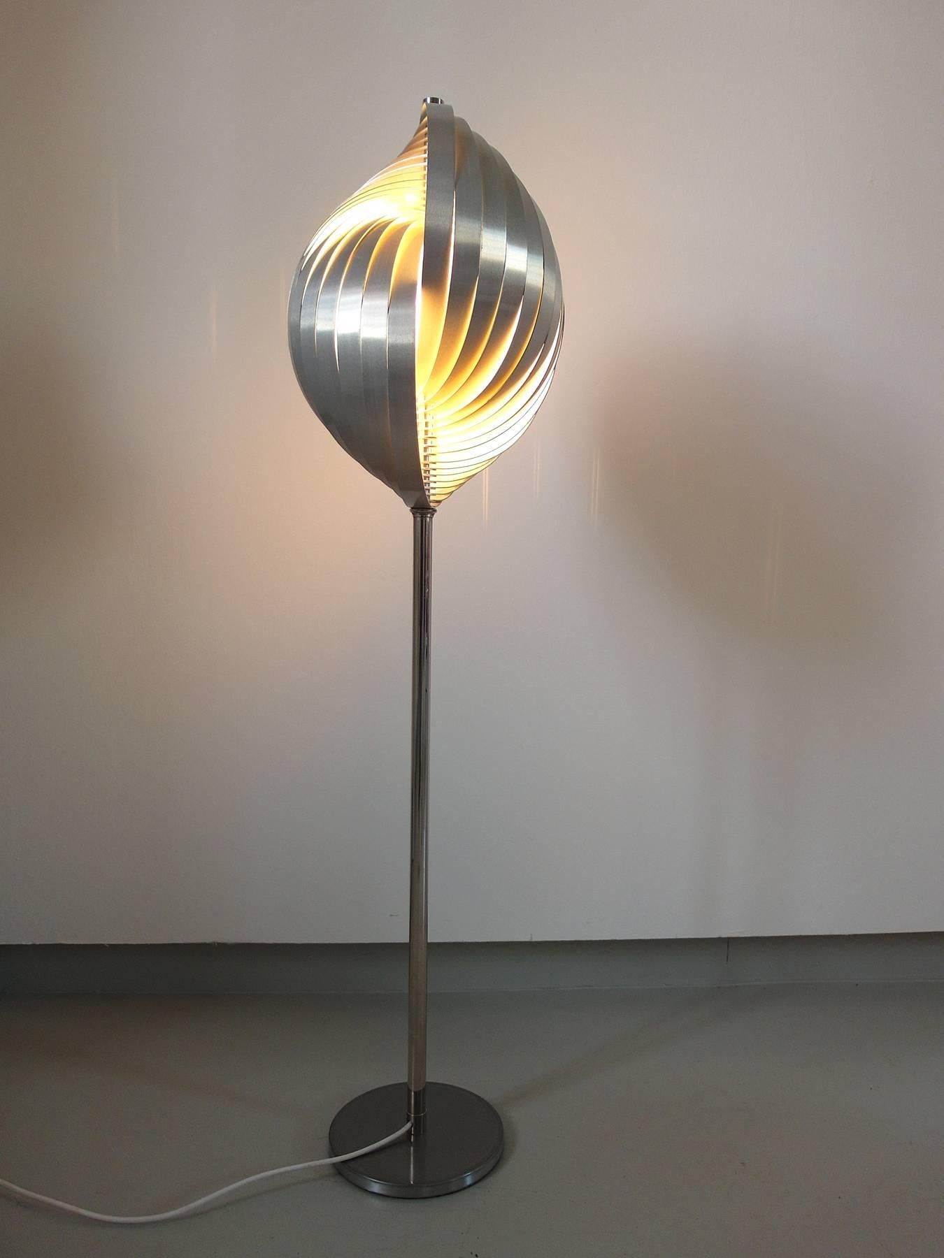 Magnificent shell shaped brushed aluminium floor lamp designed by Henri Mathieu for Mathieu Lustrerie, circa 1970.
The lamp is made of aluminium slats which form the spiral shape and spread the light in an amazing joyful and decorative way. 
The