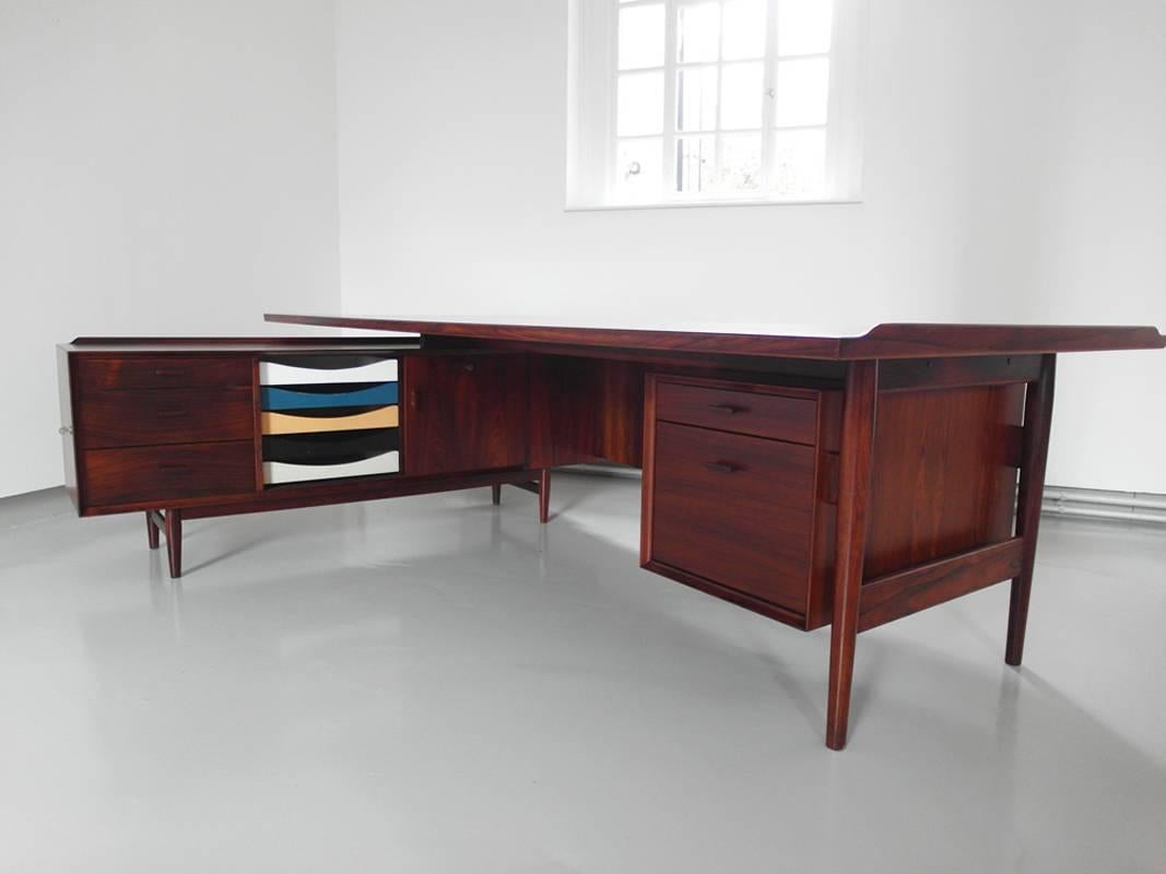 XXL executive desk designed by Arne Vodder and produced by Sibast, Denmark 1960. This very elegant L-shaped rosewood executive desk offers a lot of working space and storage options. The piece consists of a higher and lower part. This is the largest