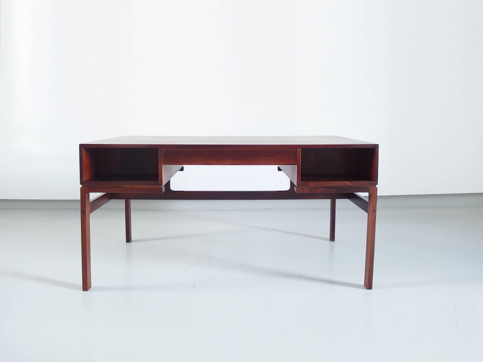 A Danish modern rosewood desk, designed by Arne Wahl Iversen and manufactured by Vinde Mobelfabrik, Denmark, 1950s. Stunning piece, which stands out for its classic design, highly figured rosewood and exposed finger joints display the desk’s