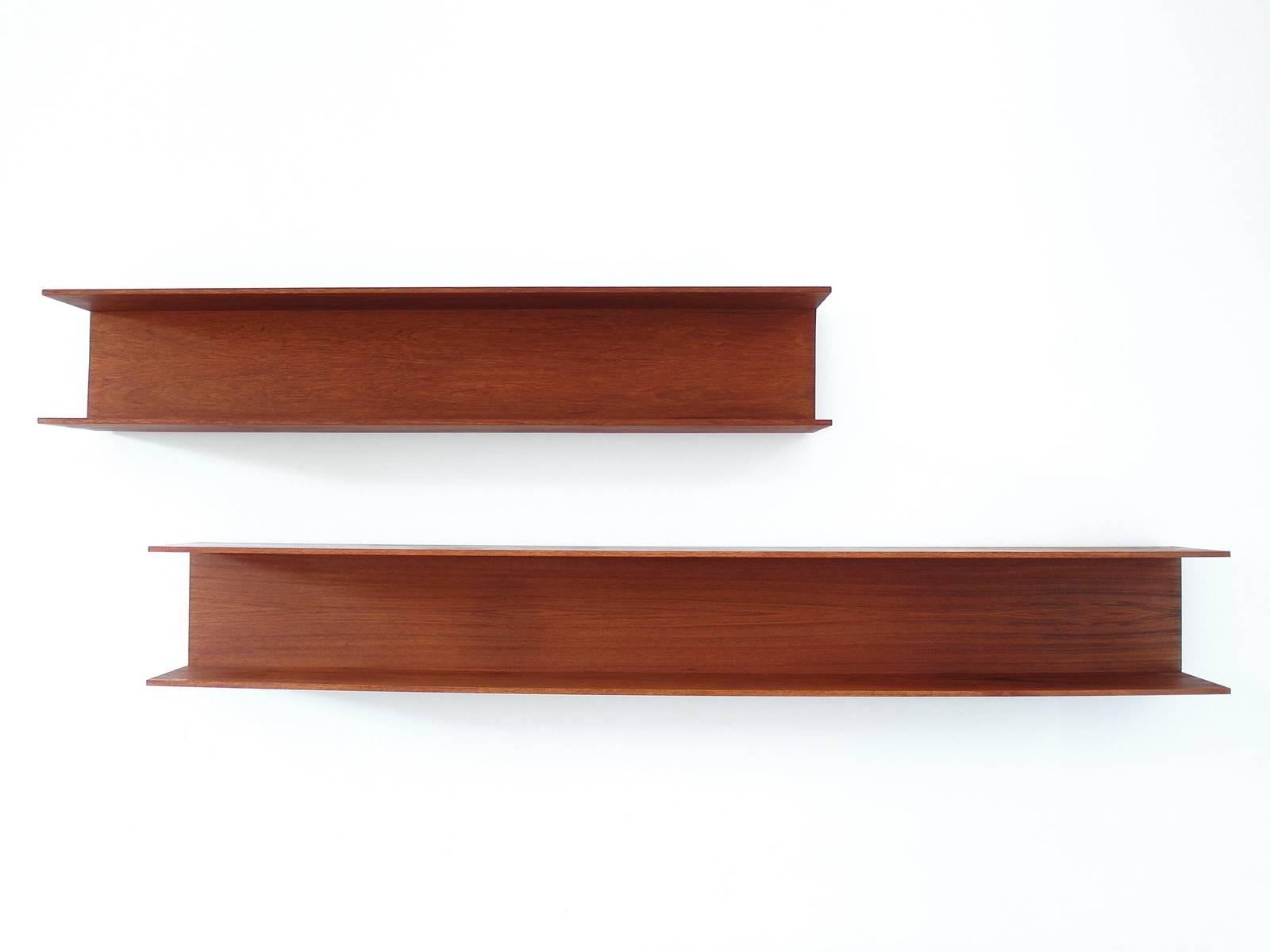 A Minimalist pair of teak shelves from the Mid-Century Modern design collection curated by Visavu. Designed by Walter Wirz for Wilhelm Renz in 1964. The shelves are 150 cm and 200 cm in width. 
German modernist design, simple and light. The shelves