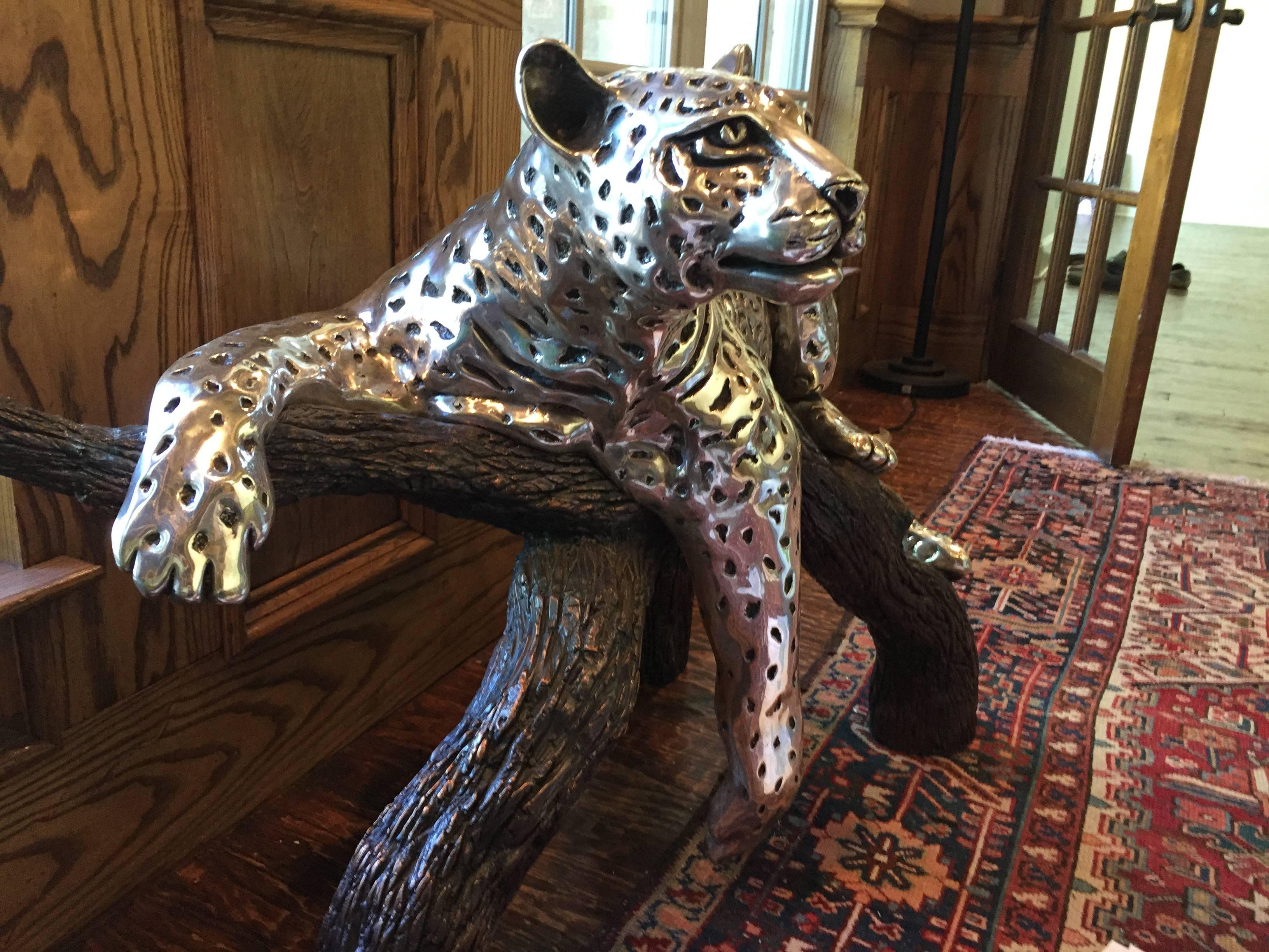 Silver plated leopard reclining on a branch by D’argenta. This exquisite limited edition sculpture by artist Ricardo Del Rio is produced by D’argenta. This sculpture beautifully captures the pensive look of a panther as it observes its surroundings