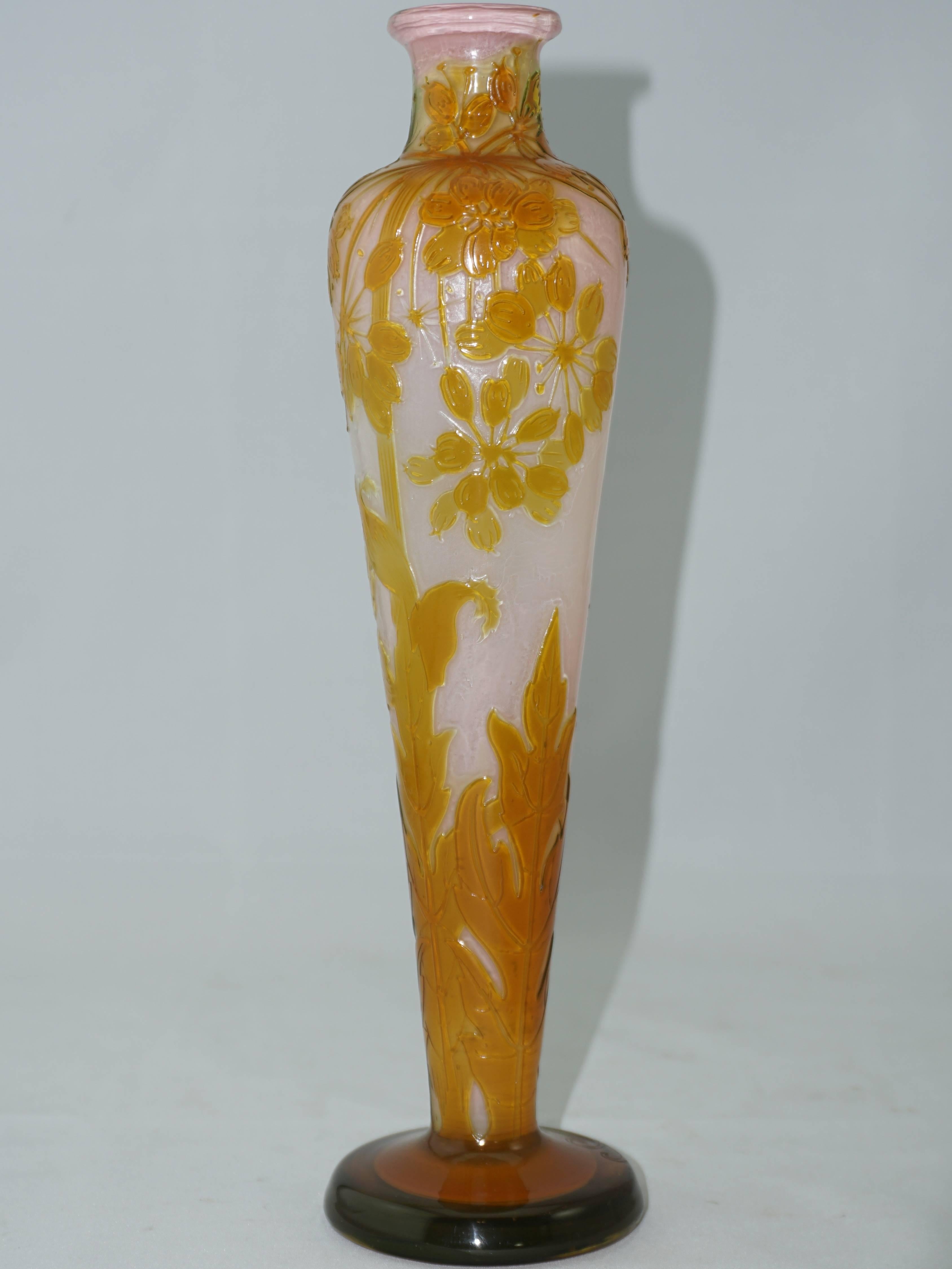 This tall and slender fire polished acid etched cameo vase is cased in a lovely pink and cream for a stunning effect of the wet look of fire polishing in the foreground. Orange and yellows dominate the foreground with etched leaves and seeding