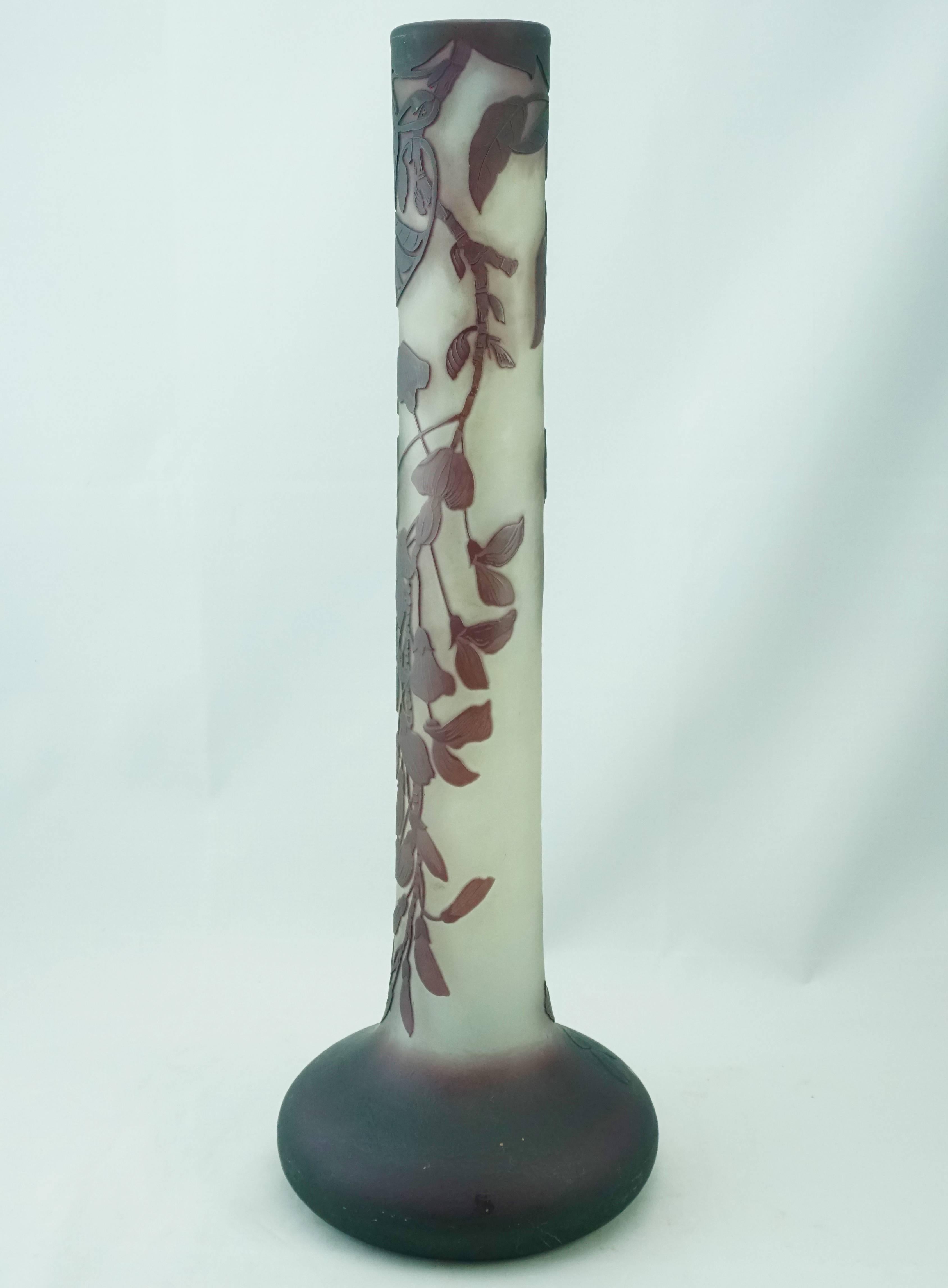 A large Galle purple over cream overlay acid etched and wheel carved eaves and hanging flowers glass stick vase. Nancy, France, circa 1900

Marks: gallé

Measure: Height 17.4 inches (44.1 cm)
Diameter: 6 inches.

Condition: Excellent.

AVANTIQUES is