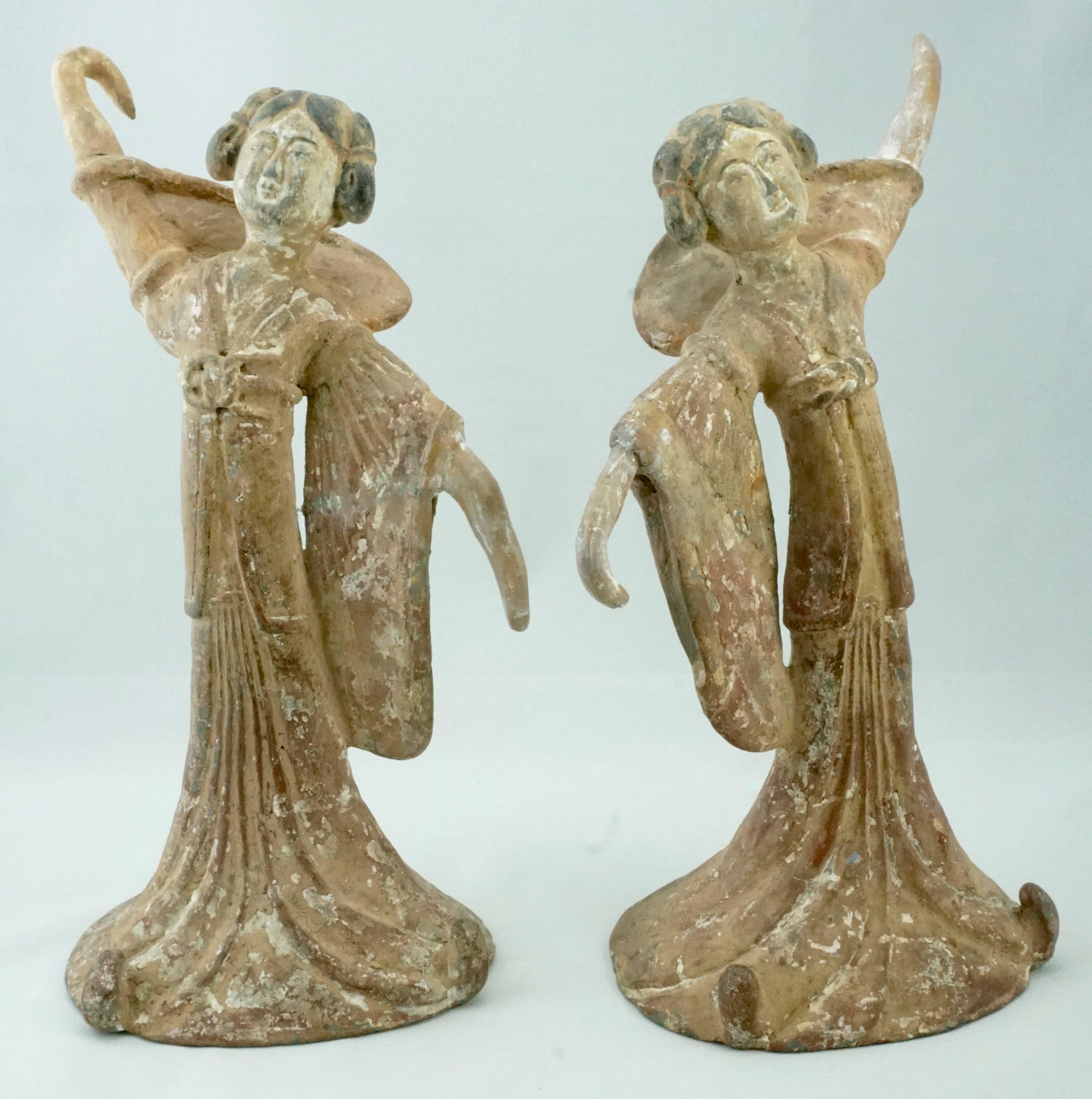 Period: Tang Dynasty (618 – 907 AD) Terra-cotta over lead clay

A pair of Tang Dynasty female dancers. Both ladies are wearing a long flowing dress with flared sleeves. Their facial features are accentuated with black and white paint and their hair