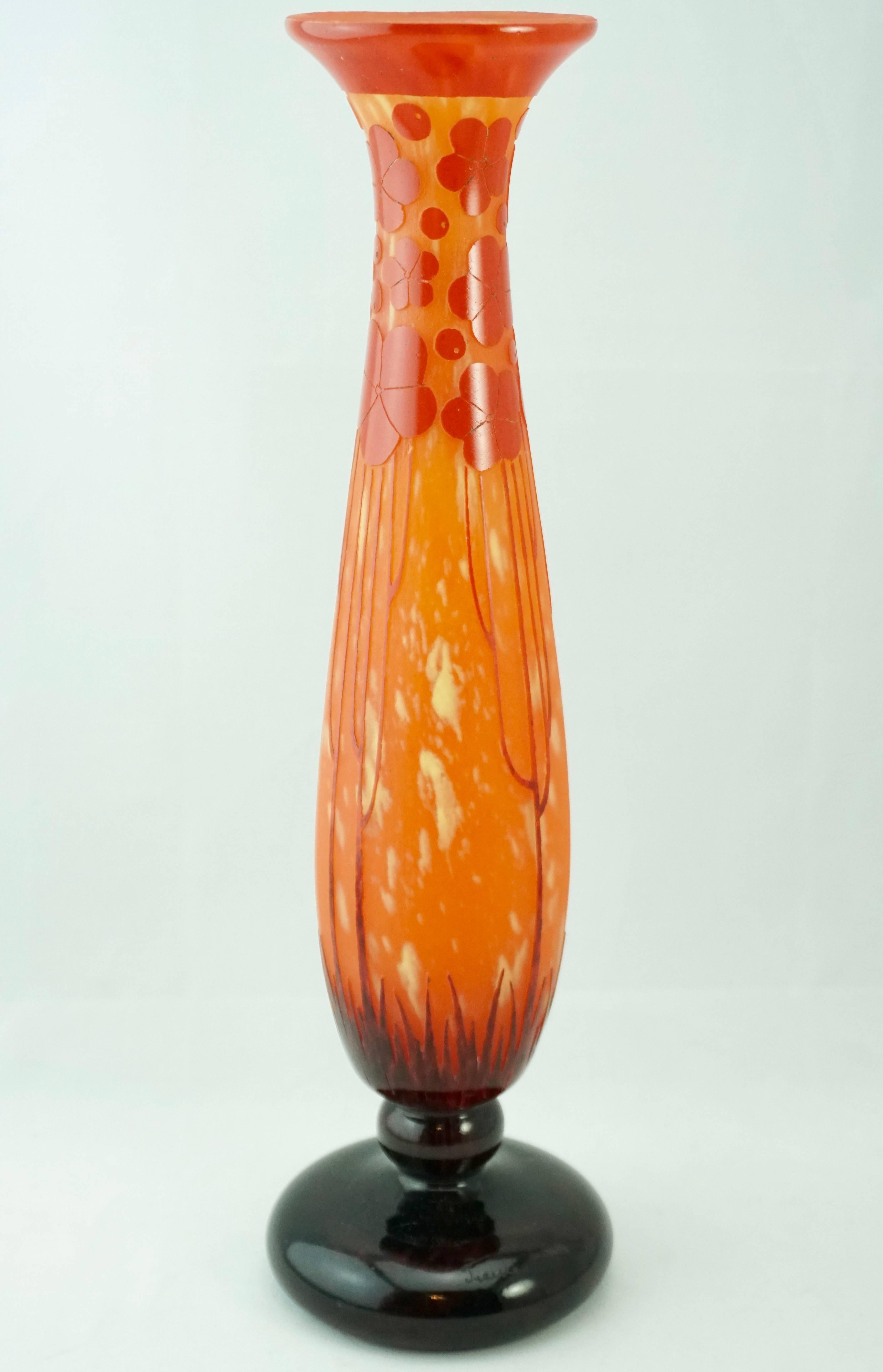 This French Art Deco cameo glass vase was created by Charles Schneider (1881–1958) for his Le Verre Francais line. The vase in the “Cardamines” cutting was produced from 1924-1927. An orange speckled with yellow ground is overlaid with red to violet