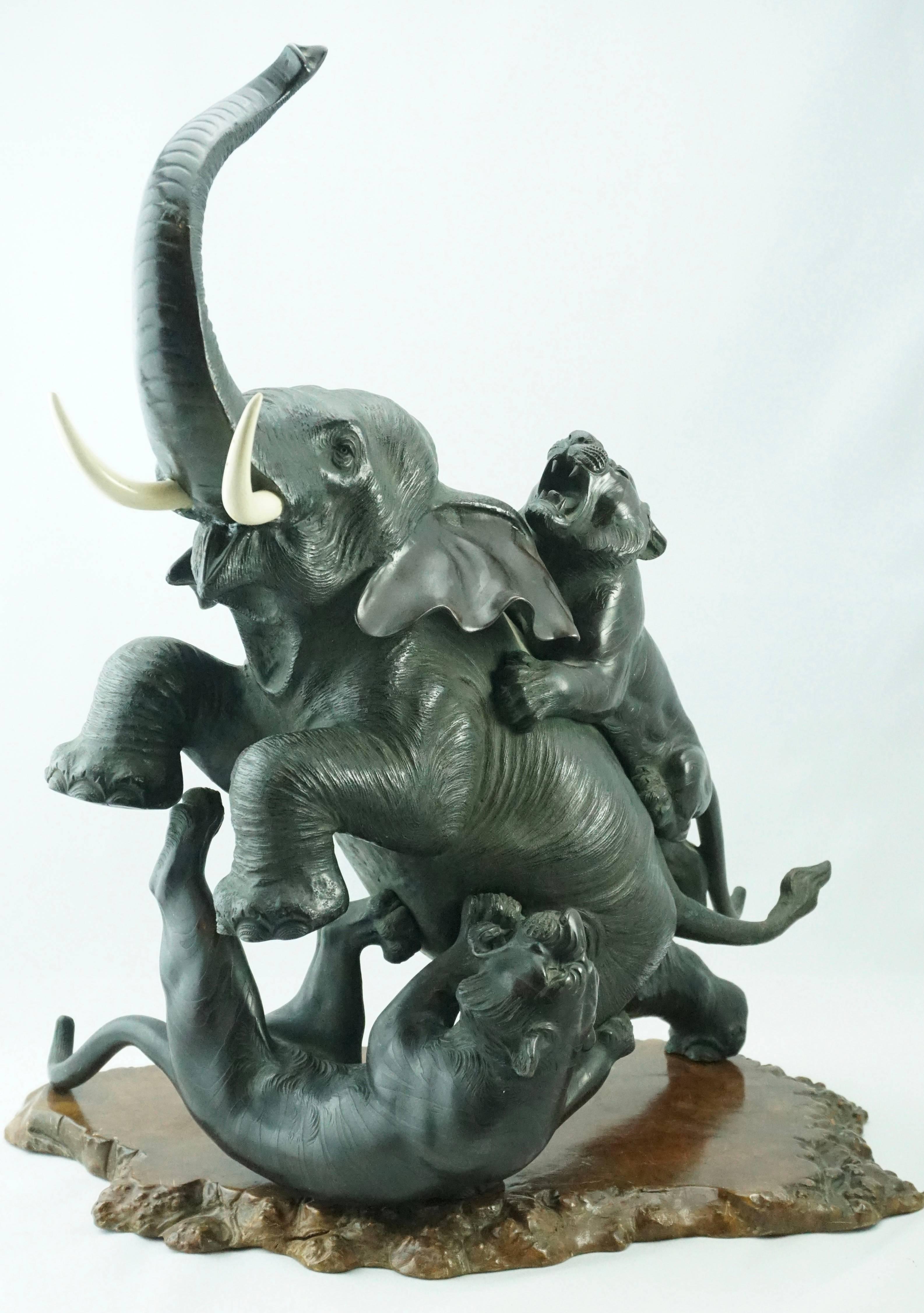 Japanese Meiji Genryusai Seiya bronze elephant and tigers, circa 1890.

This moving and detailed bronze grouping depicts a savage attack by two viscous tigers on an Asian male elephant that refuses to go down without a fight. The hand chiseling on