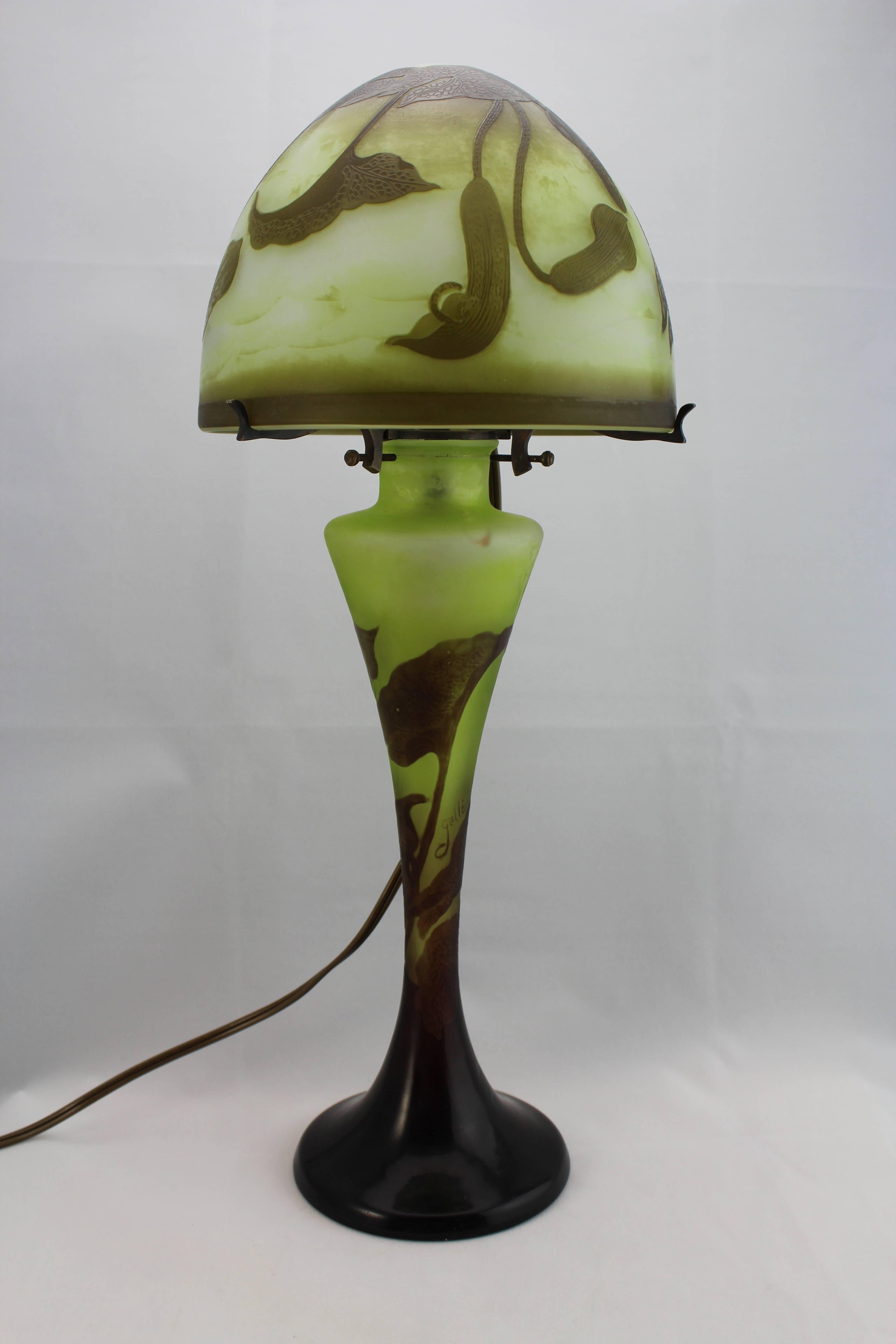 Authentic Emile Galle Cameo lamp, circa 1900 cameo, acid etched with three colors; cream, green, brown and purple. The lamp displays an art nouveau seaweed and aquatic motif. Perfect condition with only a few scratches around fitting.

Please