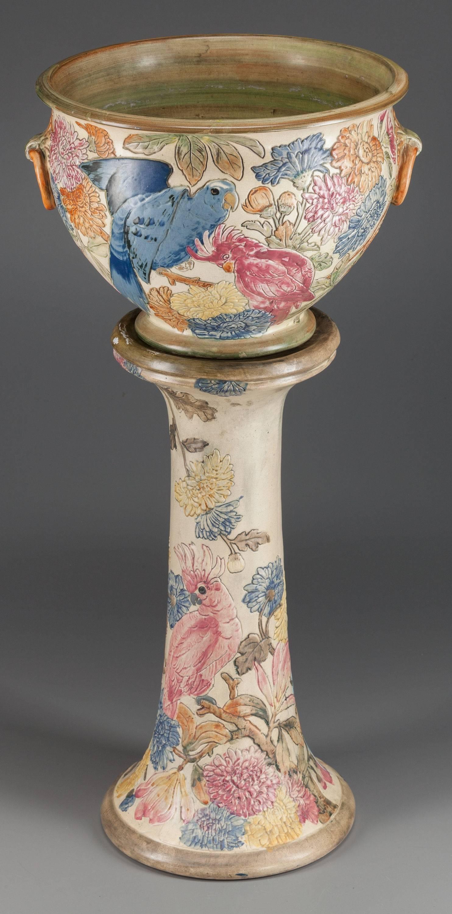 WELLER POTTERY PARROT JARDINIÈRE AND PEDESTAL, Decorated by Rudolph Lorber, Zanesville, Ohio, circa 1919 
Marks: A 
32 inches high (81.3 cm) (jardinière on pedestal) 
The jardinière and pedestal decorated with polychrome parrots among