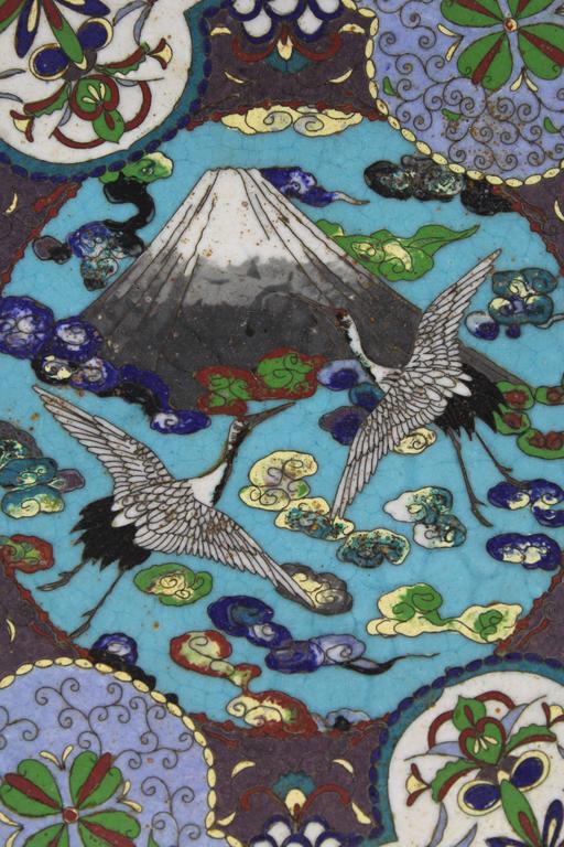 Japanese antique Meiji period cloisonne charger.
This cloisonne is intricate and masterfully executed representing mount Fuji with two white cranes in flight. One of a kind with beautiful greens, blues, browns and purples. A masterpiece of cloisonné!