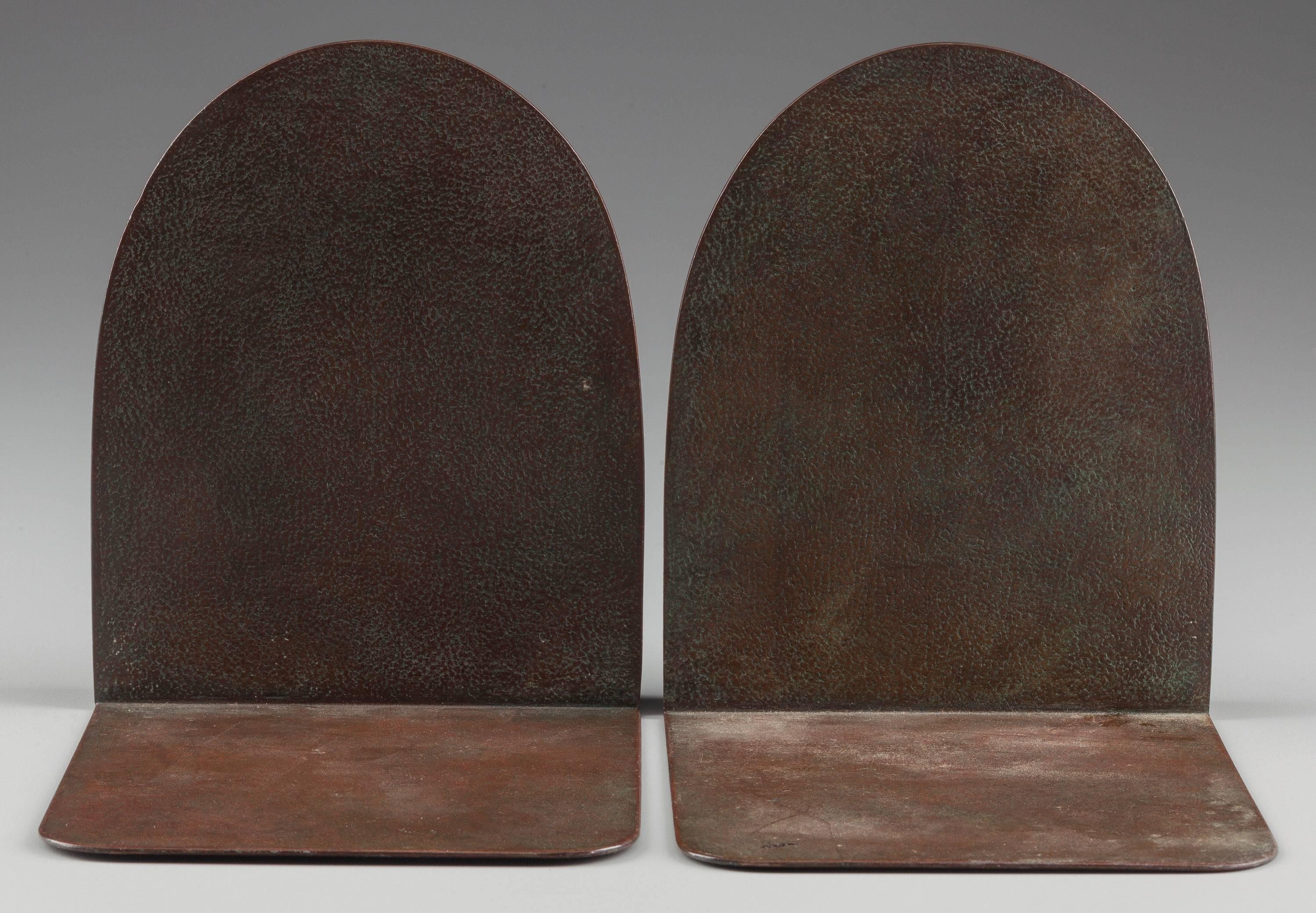 Tiffany Studios “BUDDHA” bookends. #1025 fine Tiffany sculpture bookends are impressed in the bronze statue form of Buddha beneath an arched background. Bookends are finished with a rich reddish brown and green finish and signed on the tongue
