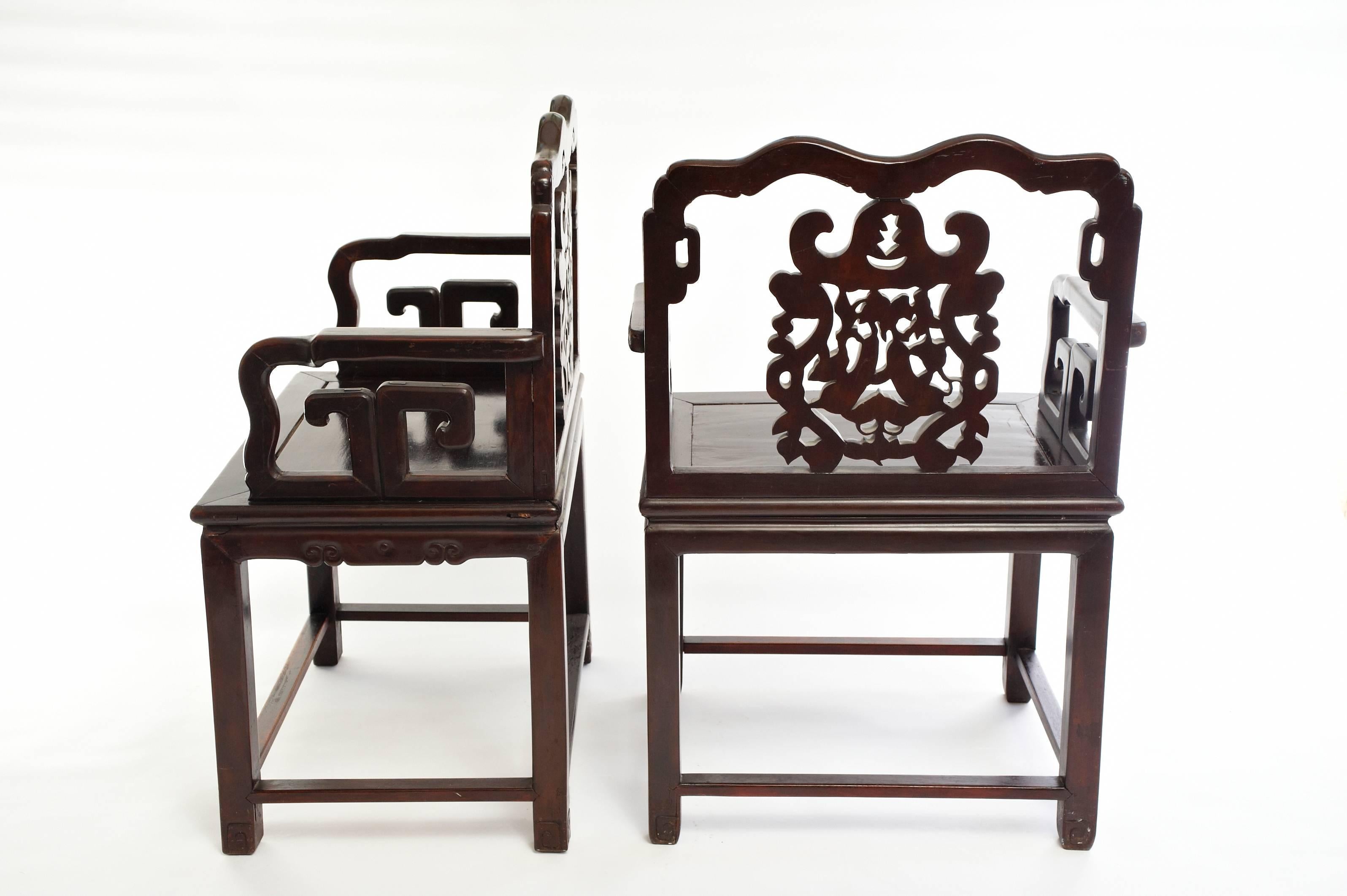 A pair of Chinese Qing rose wood armchairs. Very, very heavy; Hongmu or Tieliemu wood! Early 19th century. 

Measures: Height 38 Inches, width 25 Inches, depth 18 Inches, seat height 20 Inches. 

Very commanding and strong pieces.

Condition: Wear