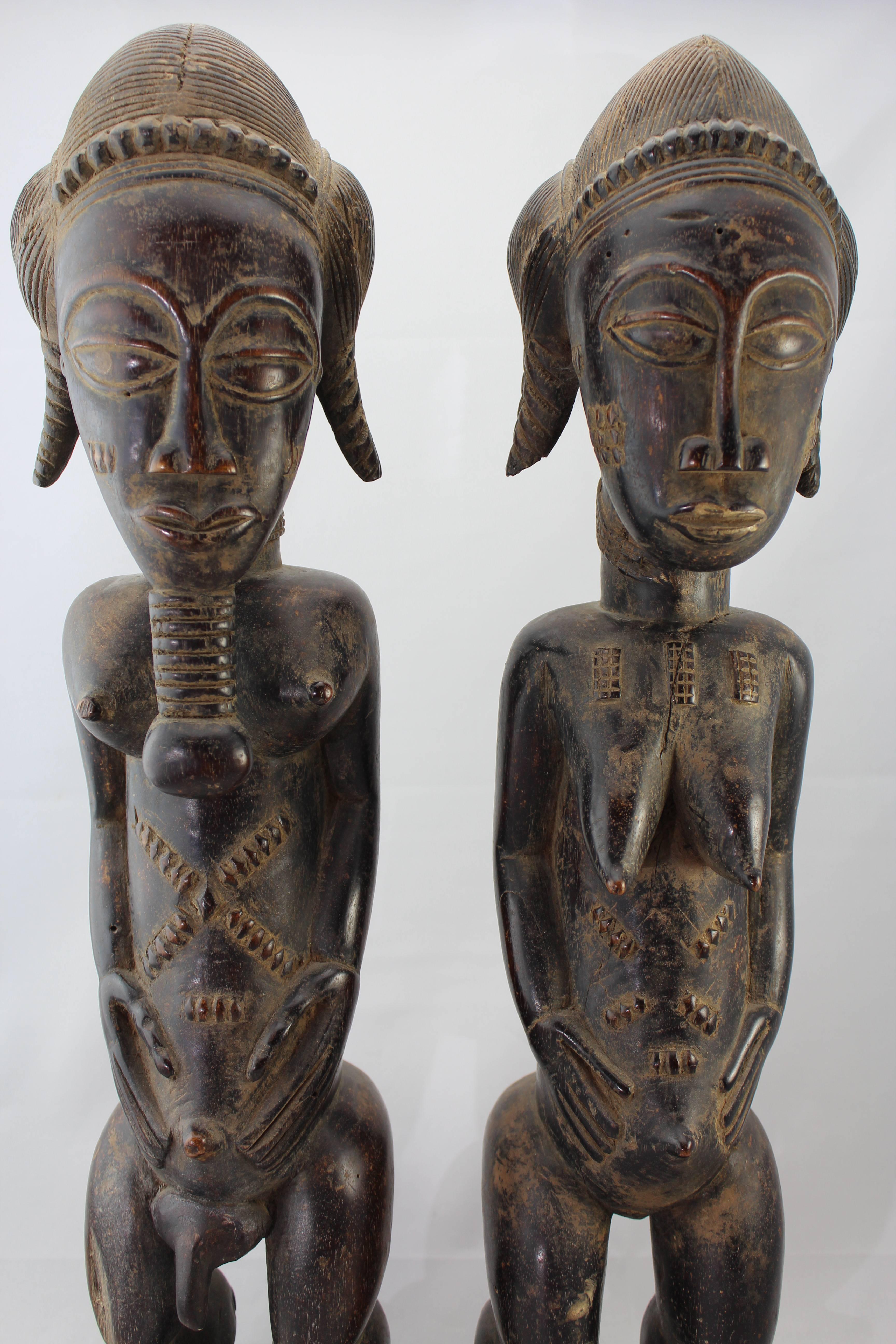 Baule people; Cote Ivoire male and female wood carved tribal figures.
Baule people.
Cote D’Ivoire.
Diviner's TOTEM.
Carved wood with dark brown patina and traces of kaolin of full male and female figures standing.
20th century or earlier!
 