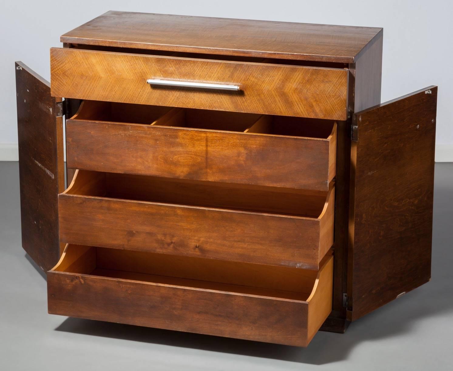 Gilbert Rohde (American, 1894-1944).
Dresser, 1933, design for living by Herman Miller Furniture Company, Zeeland, Michigan.
Mahogany and American ash veneer, brushed steel.
38 x 40 x 19 inches (96.5 x 101.6 x 48.3 cm).

From the estate of
