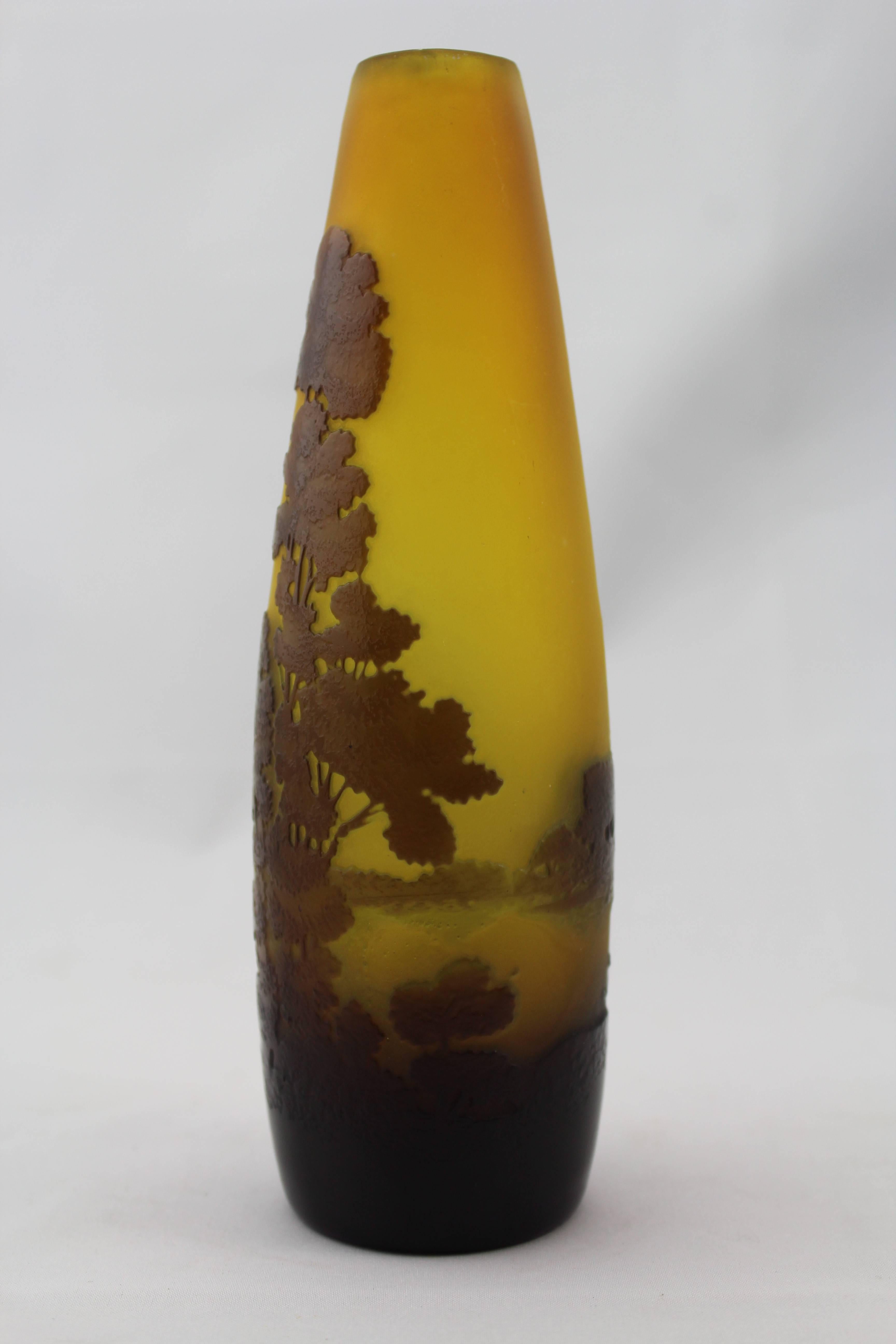 Emile Galle cameo scenic cabinet vase, circa 1900.

Colors comprise golden yellow, mild green and purple-ish brown. An Art Nouveau scene of a lake and trees. Similar to Daum Nancy.

Height: 7 inches.

Signed in cameo Galle.

No damage.