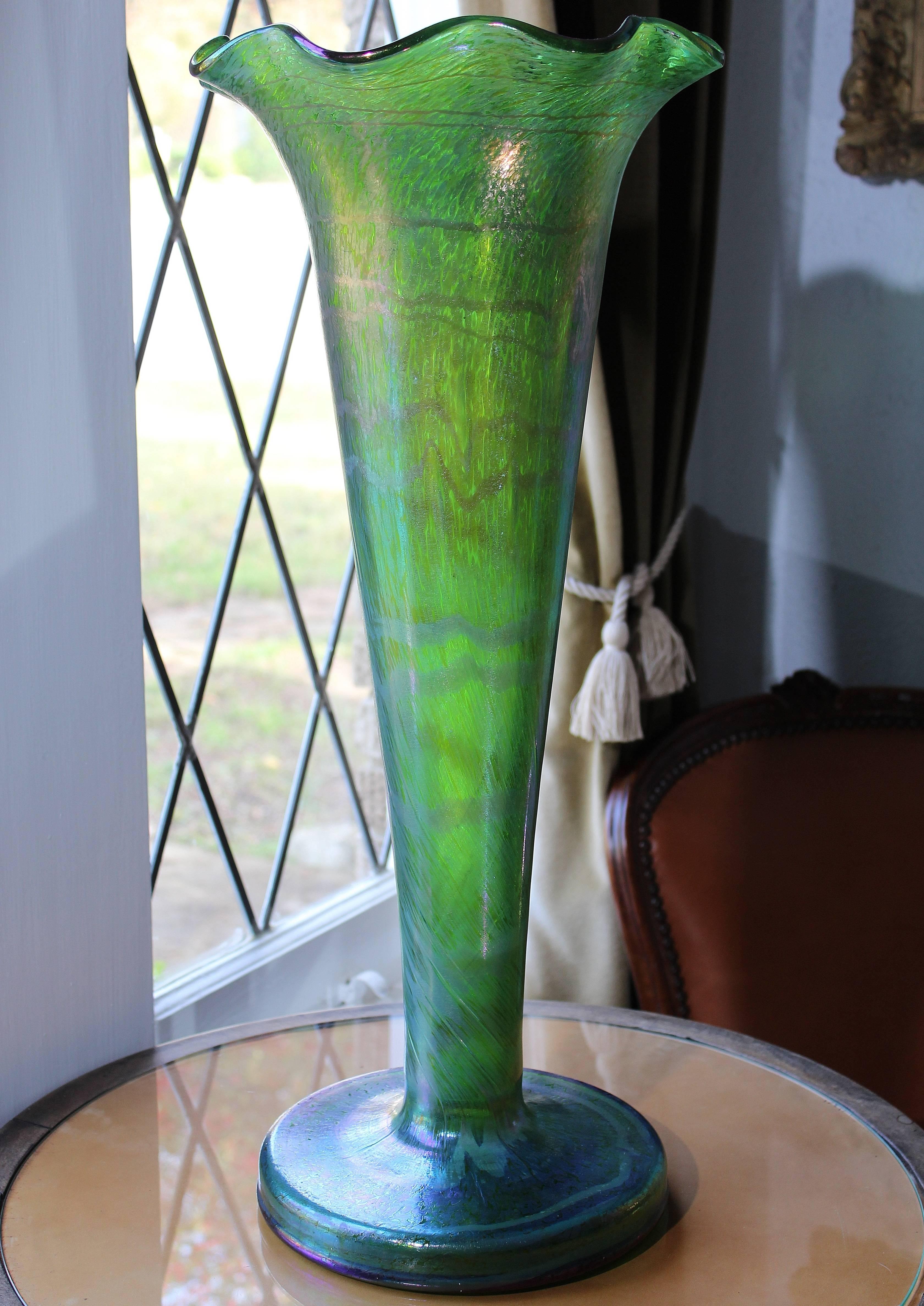Art Nouveau green and silver irredescent art glass trumpet vase from Austria, circa 1900. Mottled striated and swirled oil spot design with irredescent blue and purple favrille design. Absolutely spectacular and large!

Measures: Height: 24