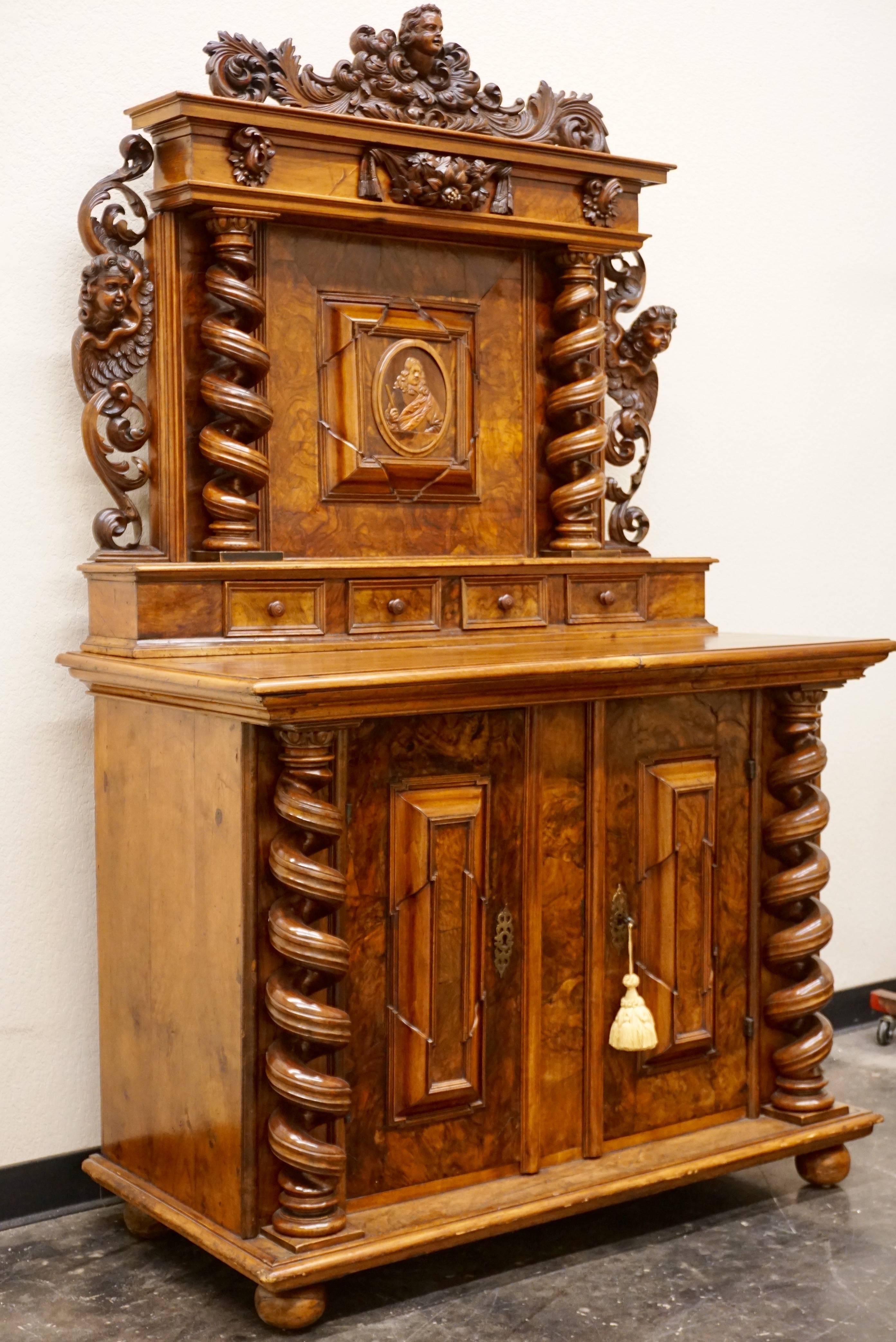 French Alsatian Louis XIII burl walnut cabinet, the upper section with carved central portrait medallion of Louis XIII (Very rare and Important) flanked by turned supports and surmounted by scrolling cherub mask pediment over four short drawers,
