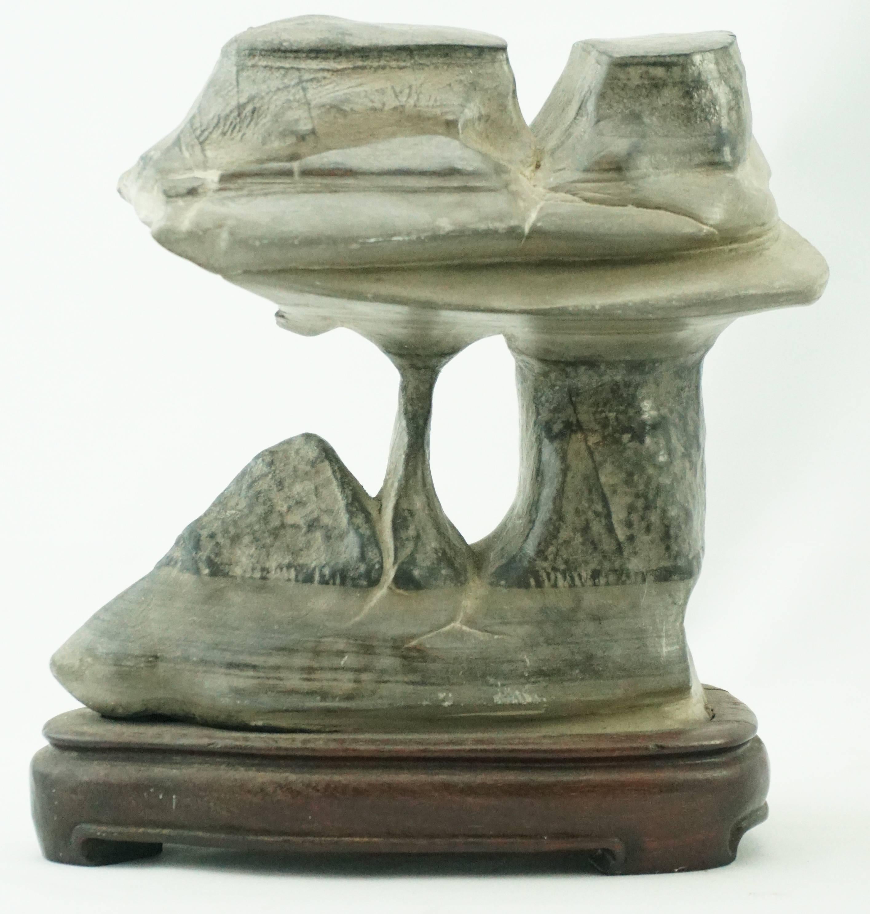 Chinese Qing scholar's stone

Measures: Height: 6.75 inches including wooden Stand
Width: 6 inches rock.

Scholars rocks can be any color, and contrasting colors are not uncommon. The size of the stone can also be quite varied: scholars rocks can