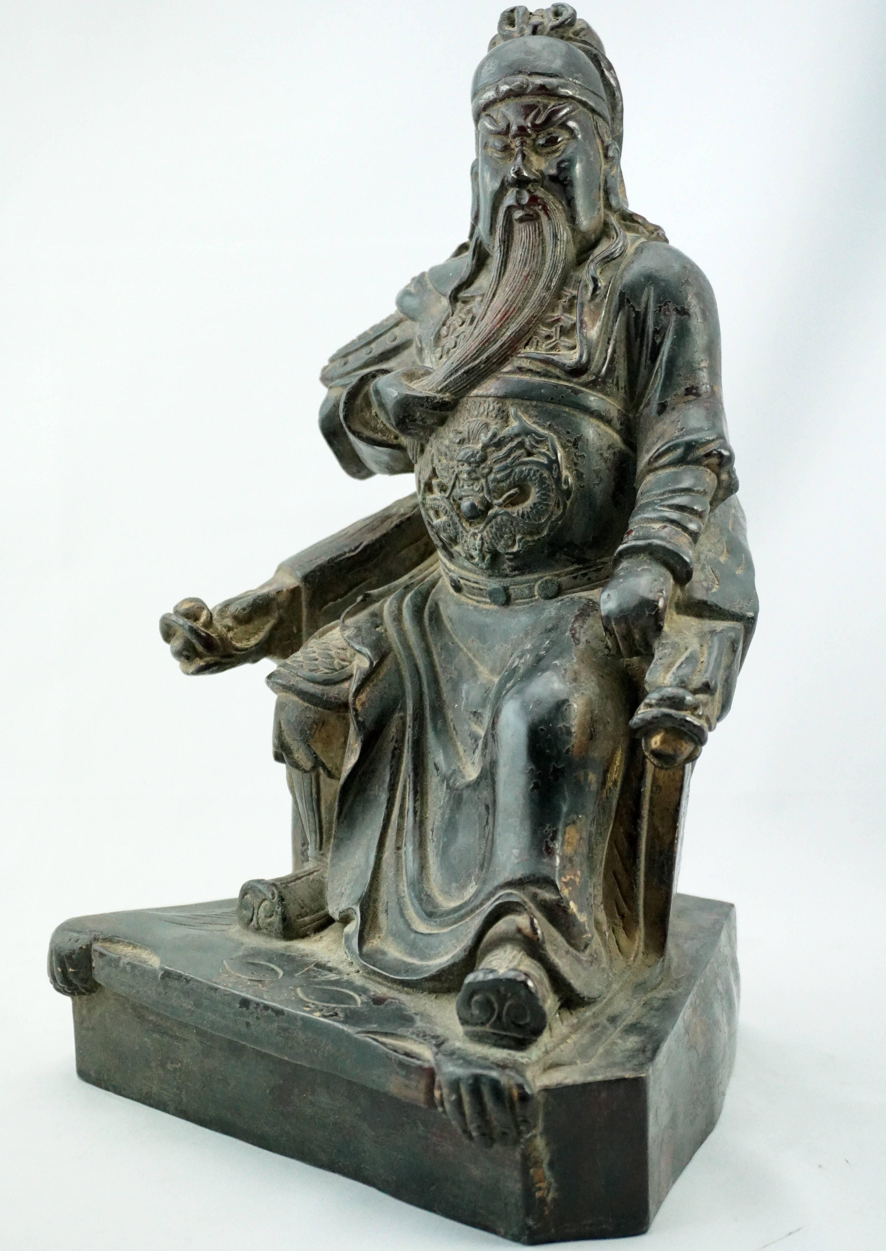 Qing 18th century bronze of a seated emperor (Possibly Guan Yu). Showing strength in ornate battle attire seated on a double armed dragon chair adorned with tiger skin backing and rug. Deatailed chasing. A very commanding piece that would adorn any