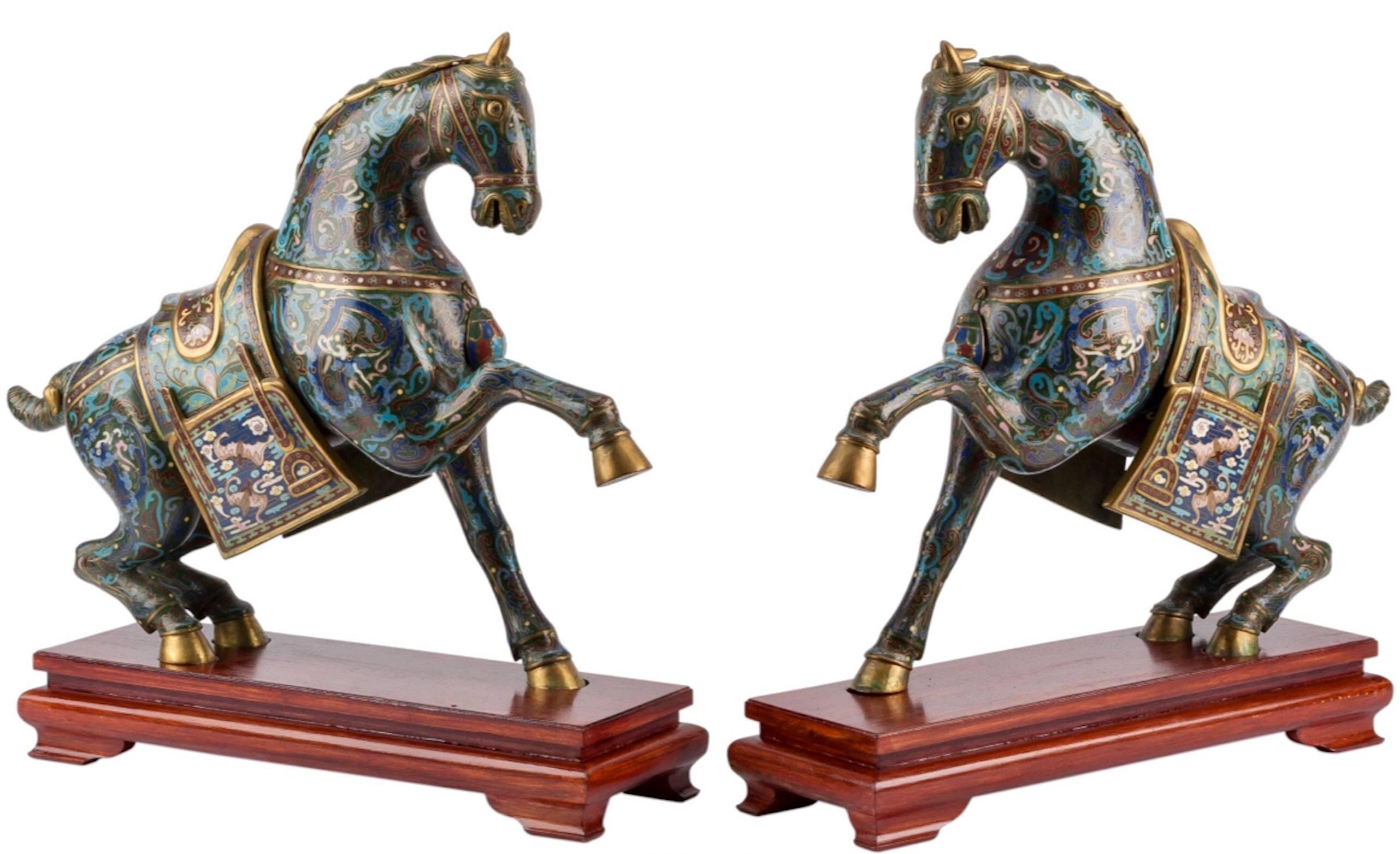 Here we have a stunning and extremely decorative pair of mid-20th century Chinese cloisonné horses on stands. They are large and will be the centrepieces of any room with archaic and typical bat Qing style. They can be taken apart at the mane and