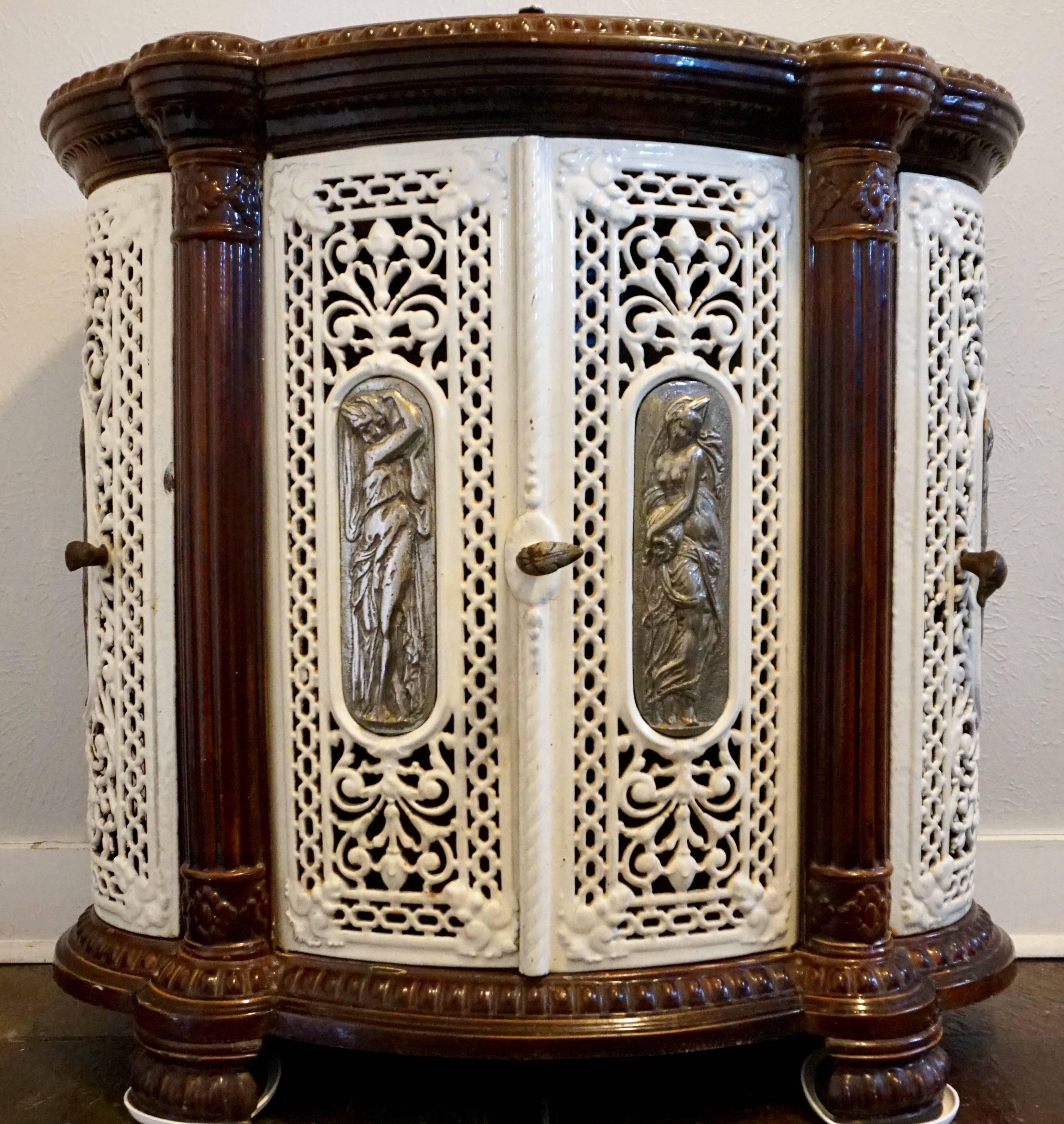 Cast iron stove from 1900 Art Nouveau. Godin design stove from circa 1900. Good for room warmth and has a food warmer. Godin was known for inovation and he knew that the only thing worse than a warm home was cold food. Five beautiful plaques adorn