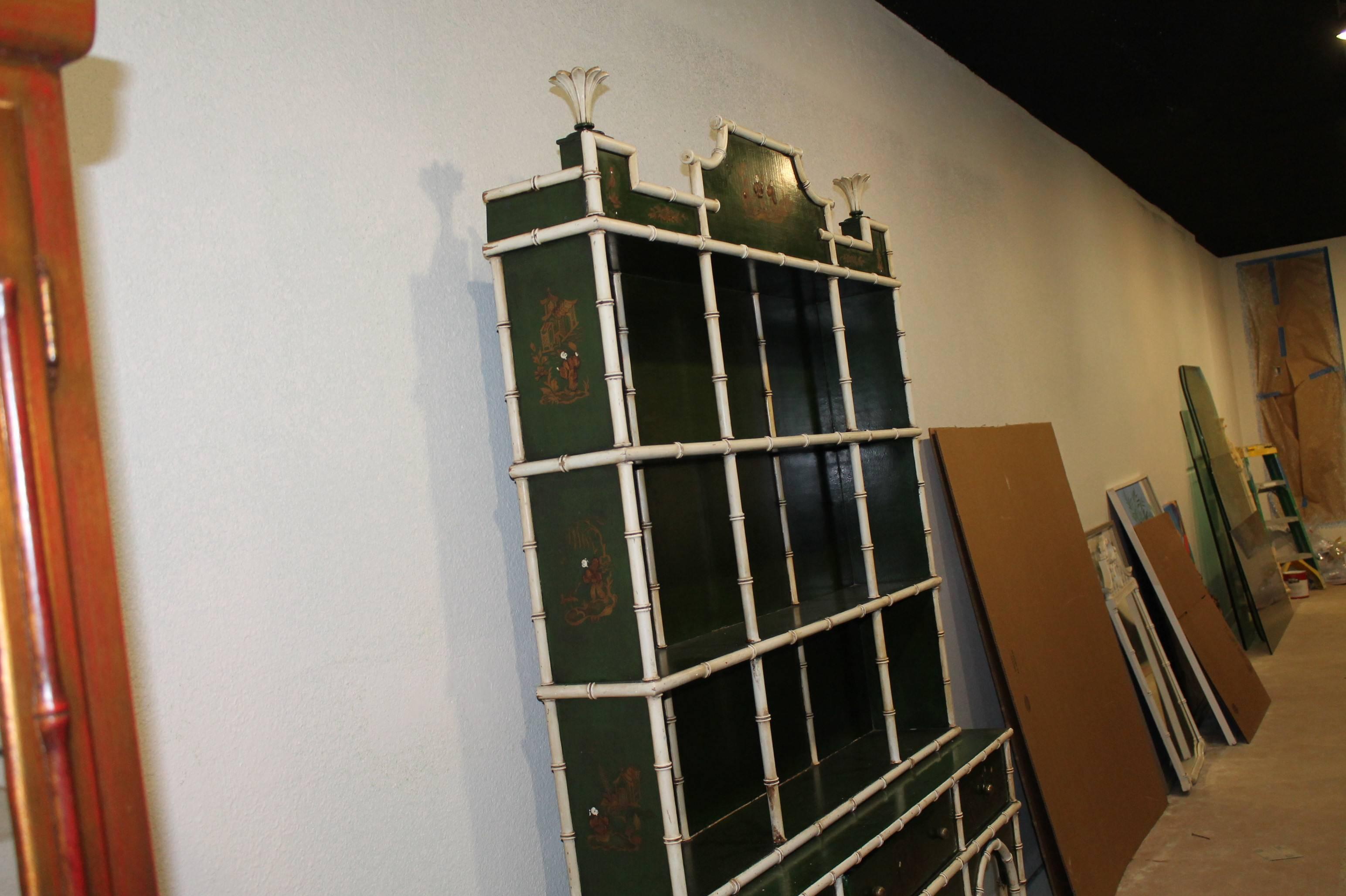 The most amazing cabinet I have ever come across. Made in Spain on back. All original paint intact. This top and bottom come apart for transport. Beautiful dark emerald green finish with intricate oriental paintings all-over the piece, faux bamboo