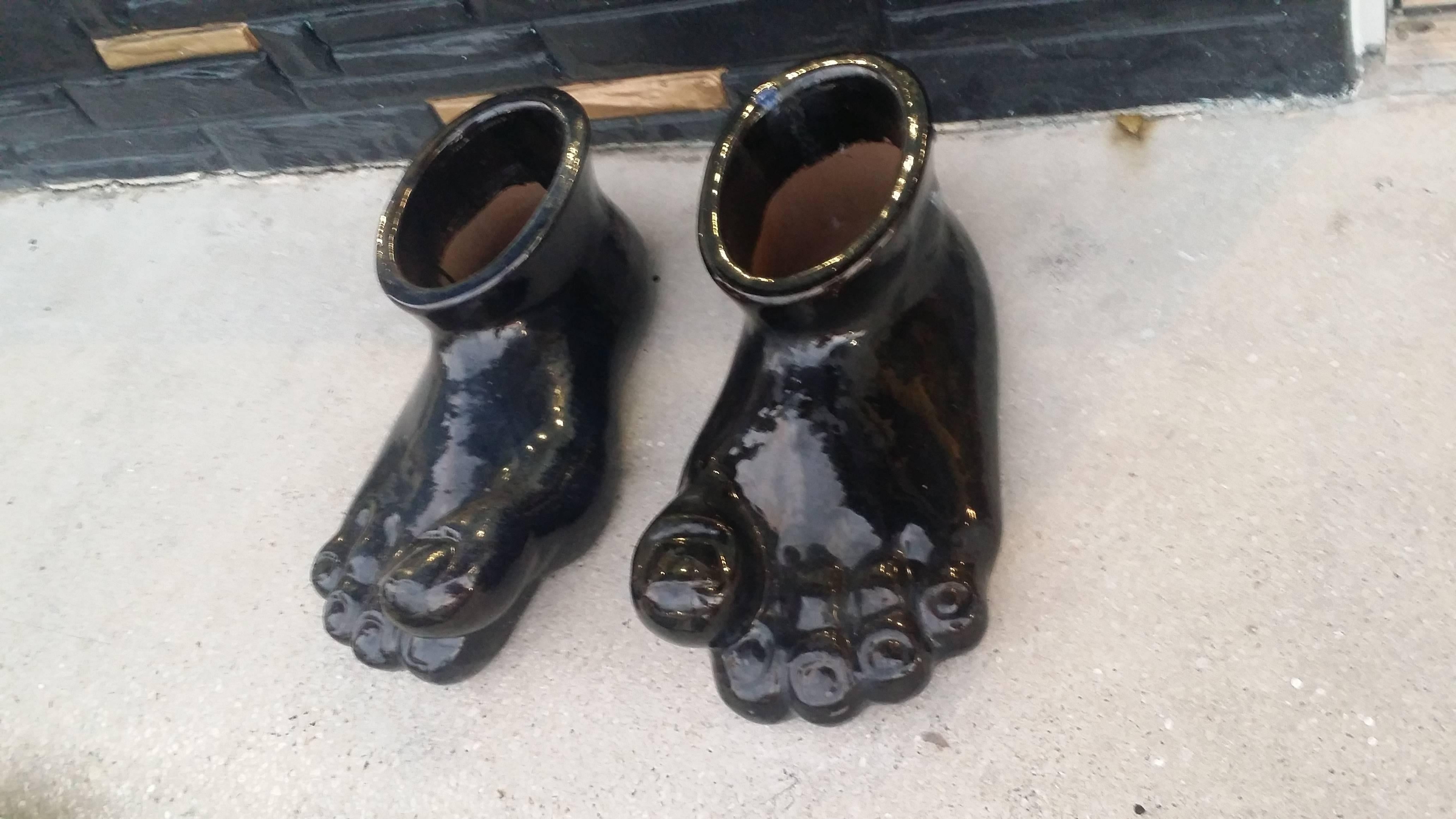 Amazing one of a kind pair of Monumental size feet, left and right, sculpture. Terra cotta glazed blue underneath with a black top coat. No chips or breaks. These are huge! Measures 23 long x 9 tall x 11 wide. You can use these as is or fill them