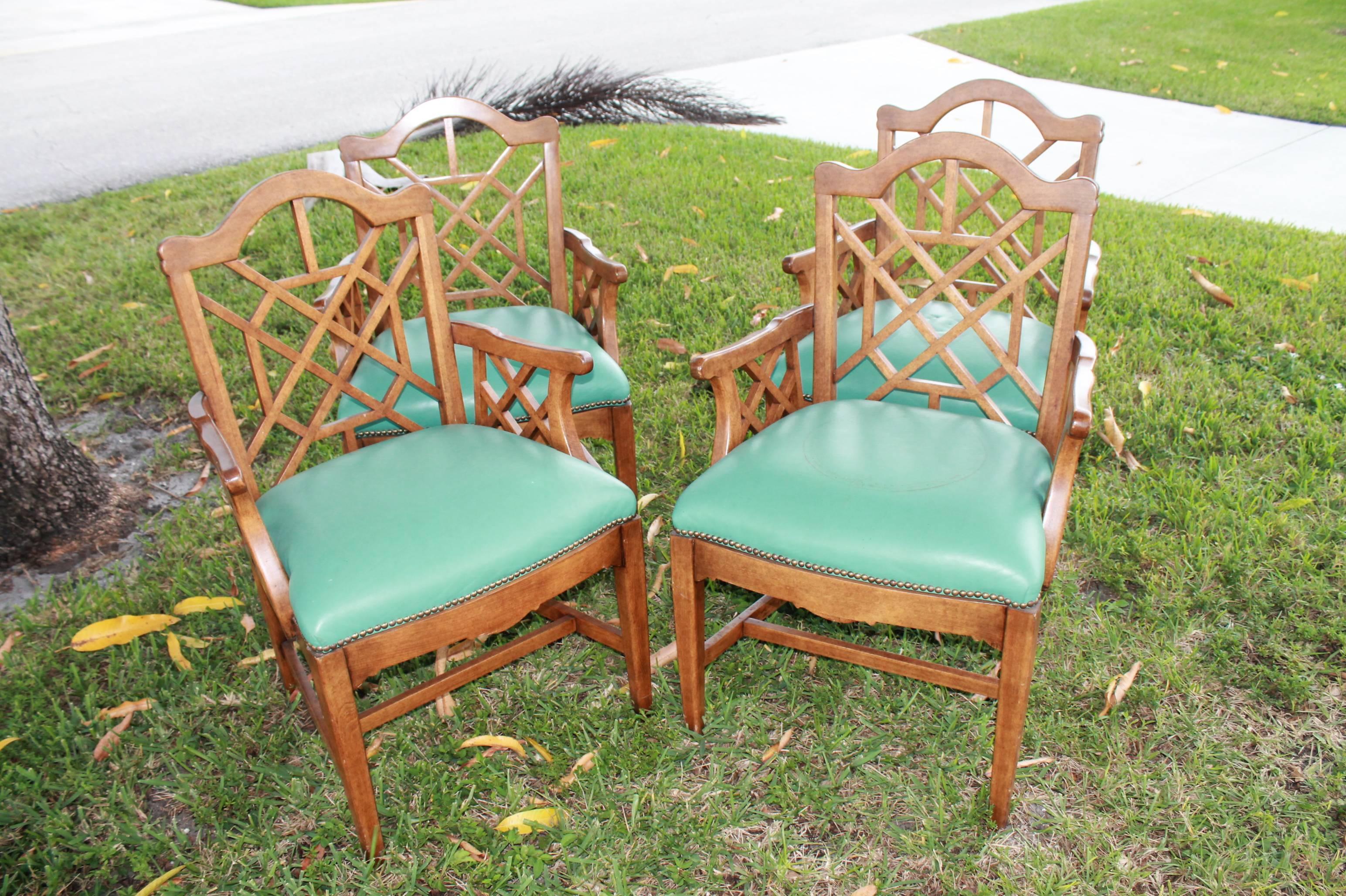 Lovely set of four vintage fretwork arm dining chairs, game table. Original wood finish and upholstery in excellent condition. Perfect for the Hollywood Regency, Palm Beach décor!
