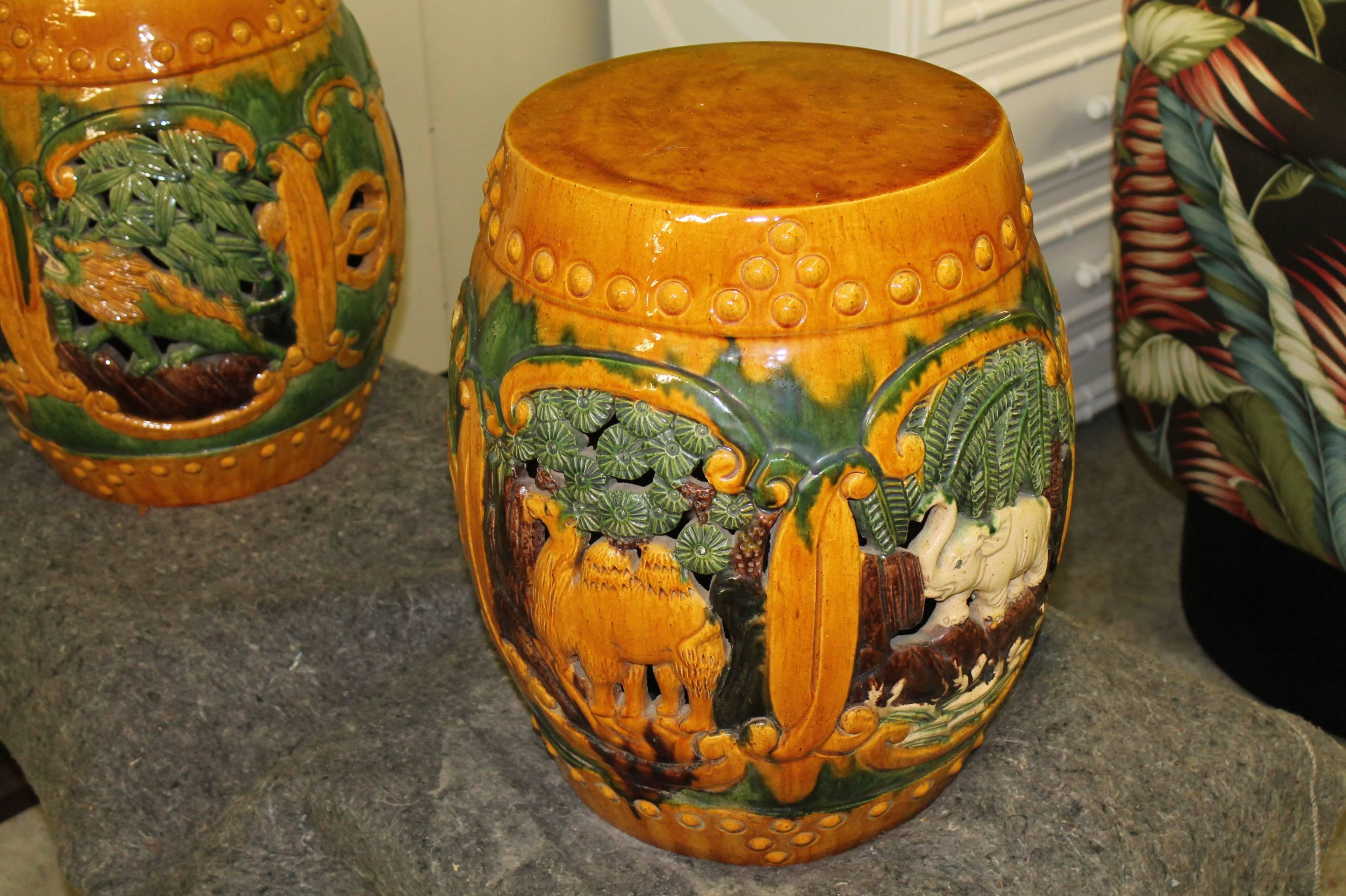 Lovely pair of ceramic drum garden stools with a safari animal motif including camels, elephants, palm trees, etc. These are very heavy and sturdy with no chips or breaks. 

