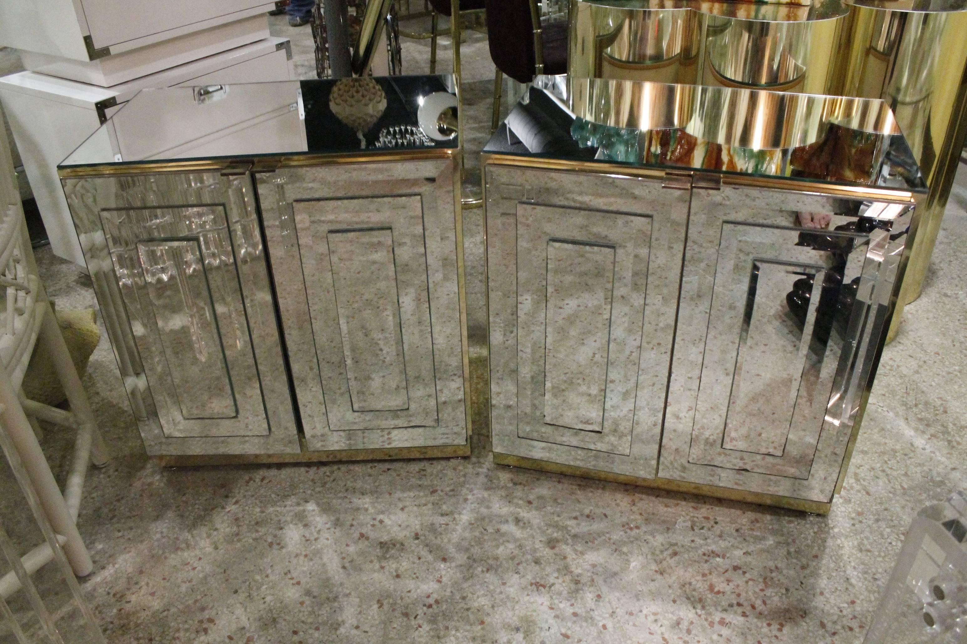 Amazing pair of vintage Hollywood Palm Beach Regency  Ello Mirrored mirror brass nightstands chests. Rare to find a pair in the mirrored with brass especially! One side of door mirror has some silver loss (pictured). 
Top measures 16" deep. I