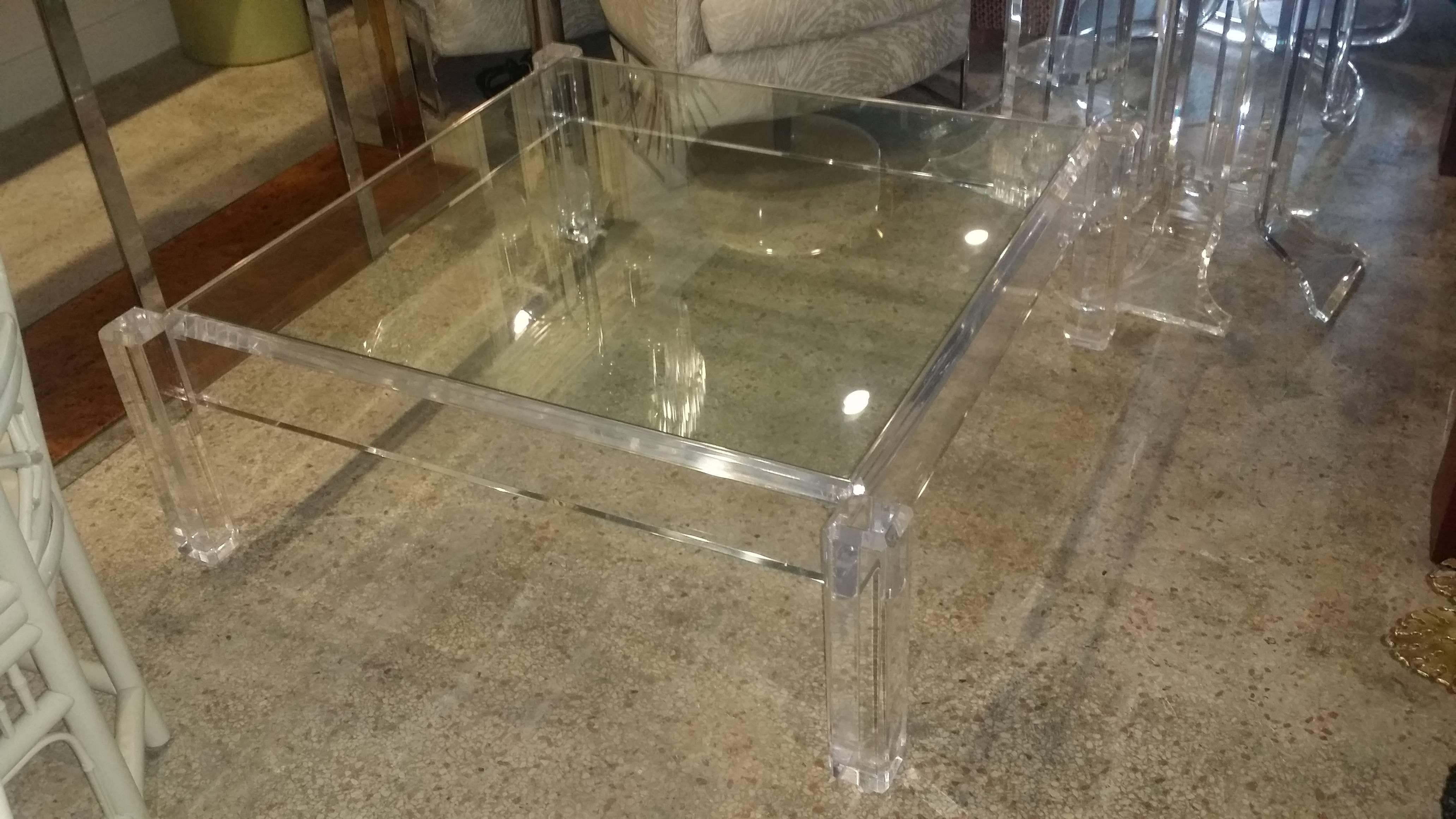 Amazing vintage Hollywood Palm Beach Regency Lucite with glass top coffee cocktail table, column style legs that are thick and chunky! Lucite is in impeccable condition! The perfect cocktail table to compliment, not compete, with any décor! 
In the
